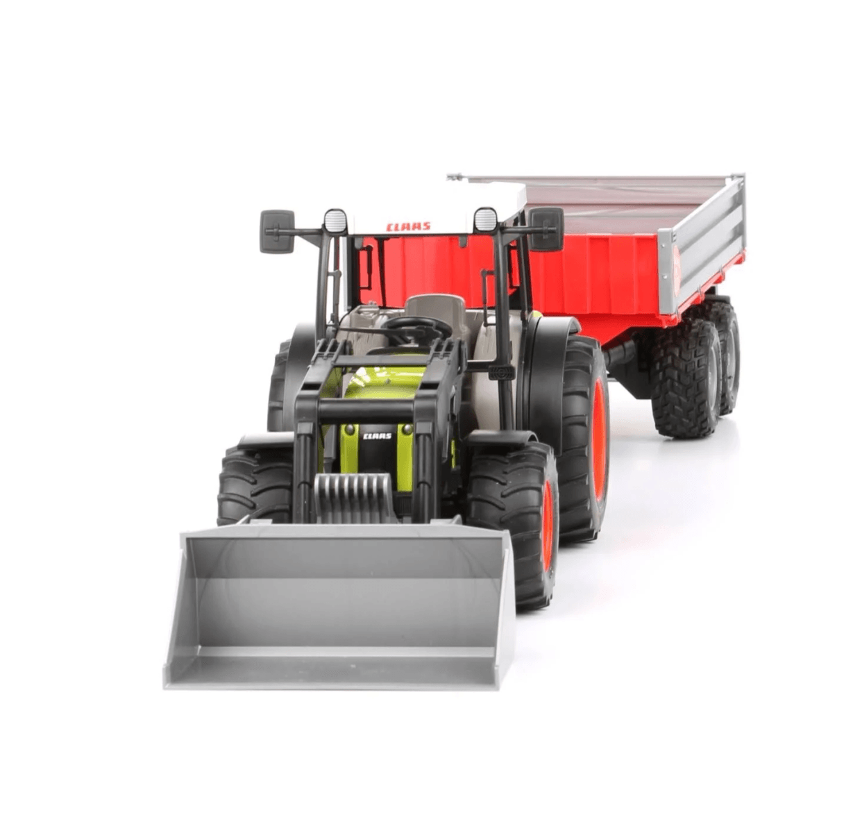 Un tractor de juguete con pala frontal y remolque rojo sobre fondo blanco.