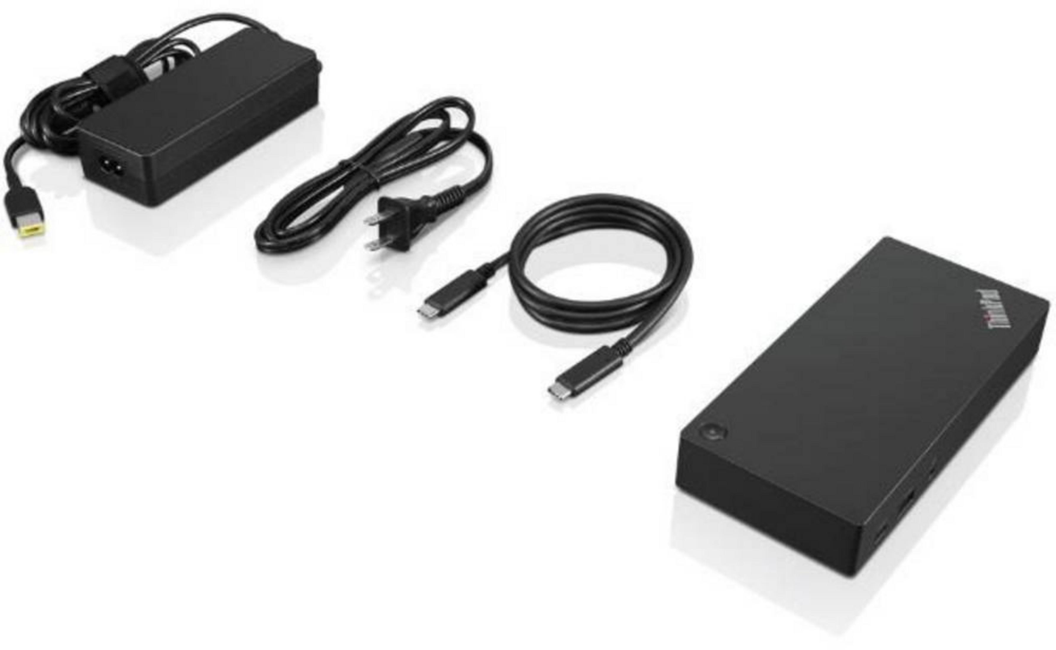 Alimentatore nero con cavi e docking station su sfondo bianco.