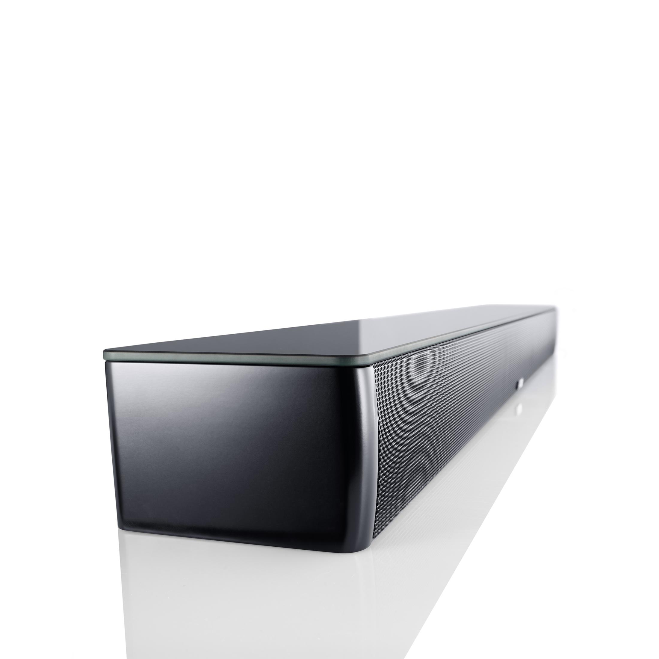 A black, slim soundbar with a glass top rests on a reflective white surface.