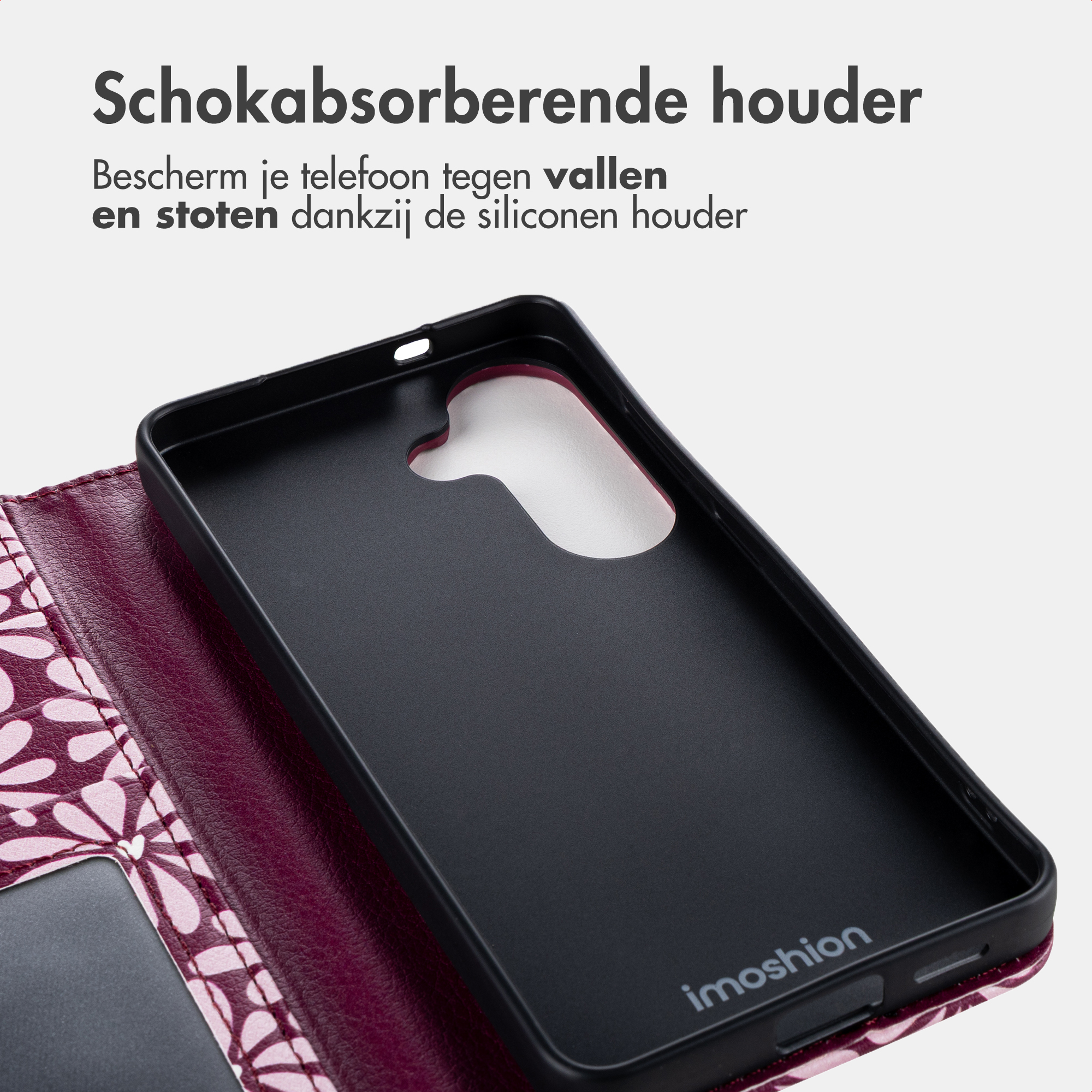 Zwarte telefoonhoes met paars bloemenpatroon aan de binnenkant.
