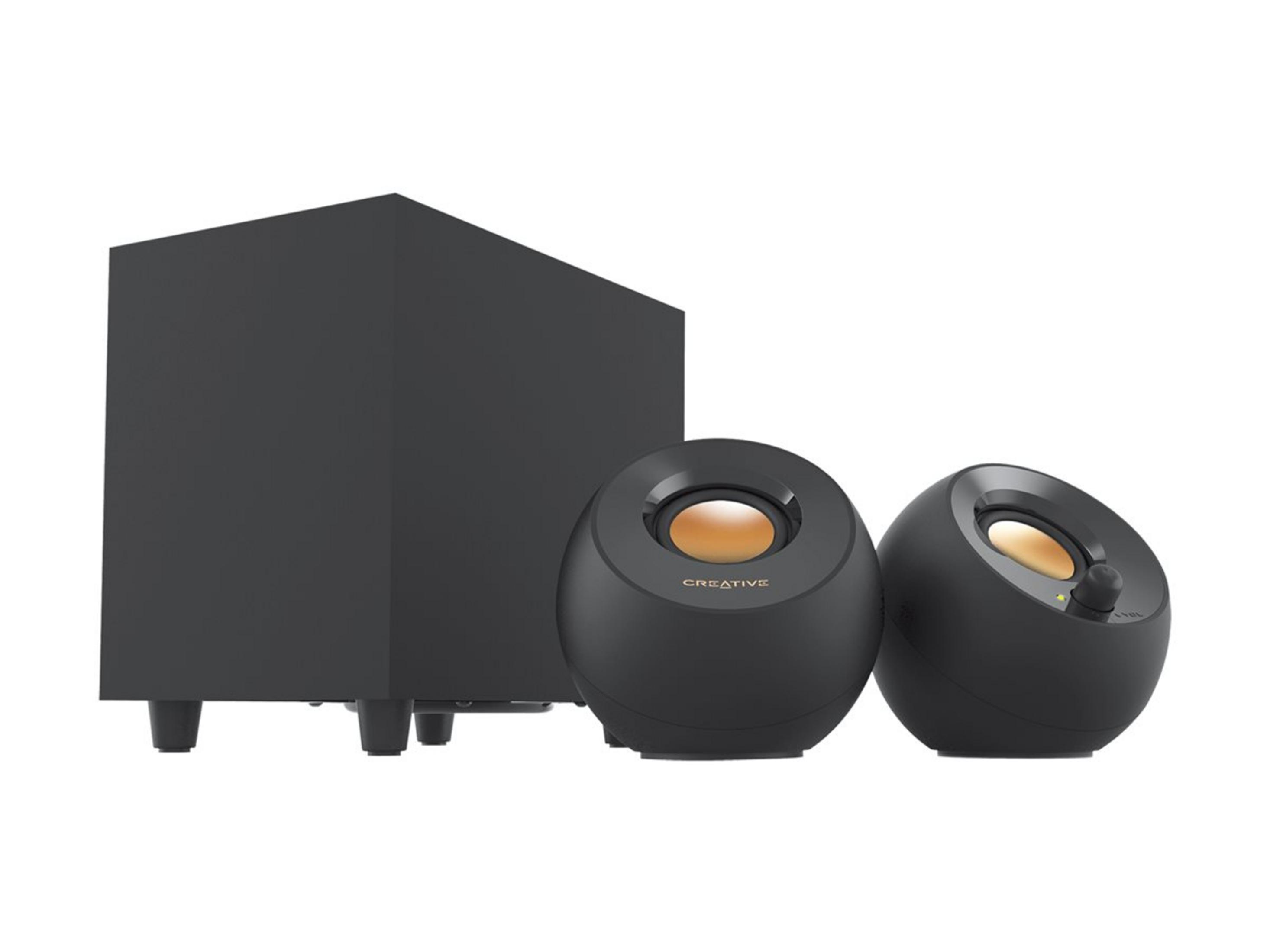 Un subwoofer negro y dos altavoces esféricos con detalles dorados.