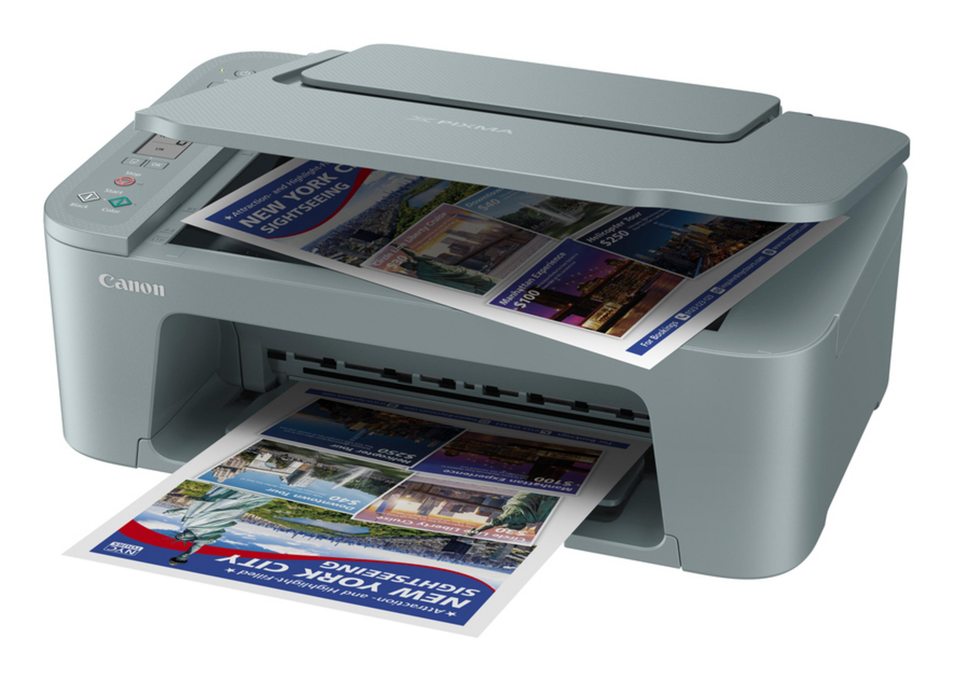 A gray Canon printer is printing brochures about New York City.