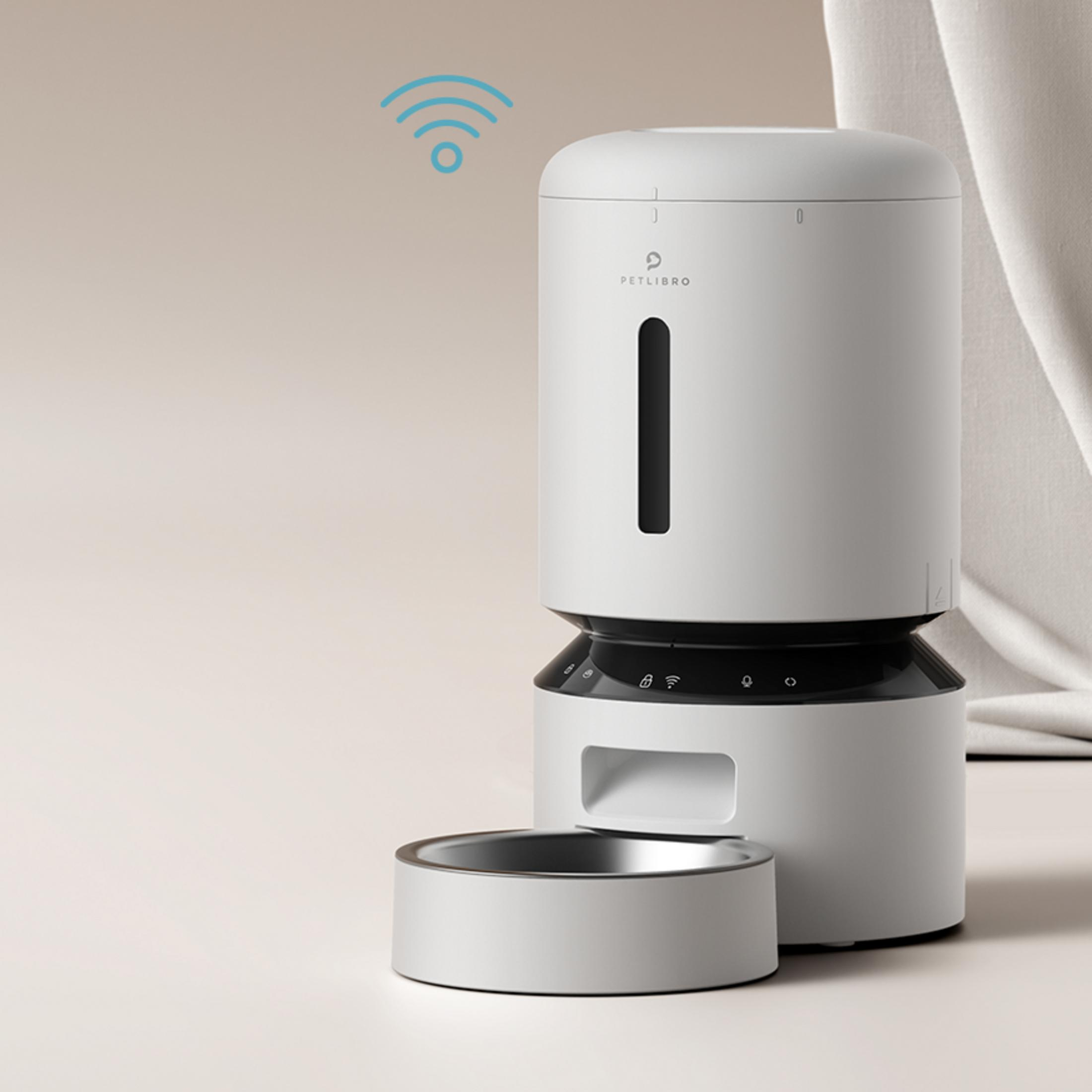 A white smart pet feeder with a food bowl and Wi-Fi symbol.