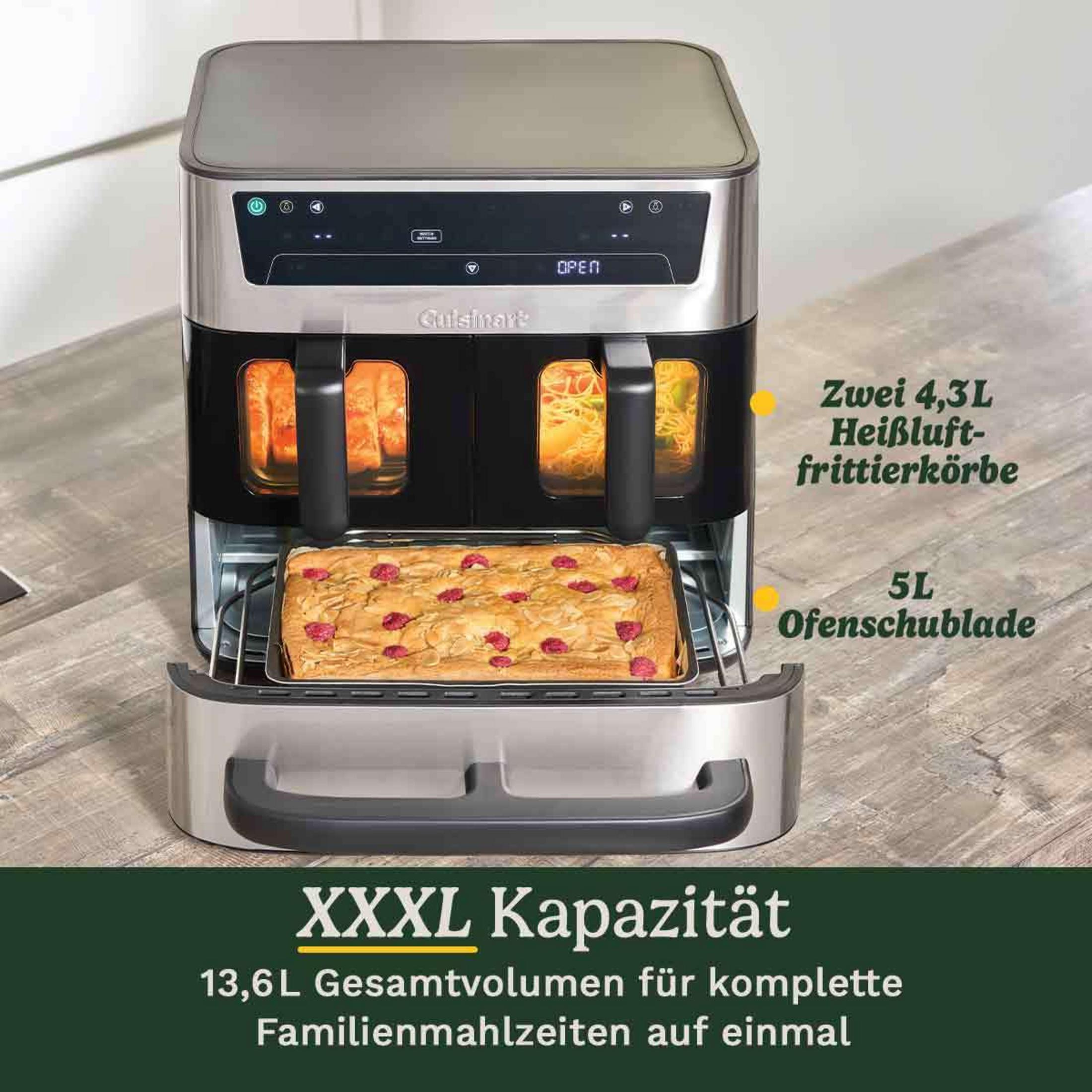 Edelstahl-Heißluftfritteuse mit zwei Körben, einem Ofenfach und einem Kuchen mit Beeren.