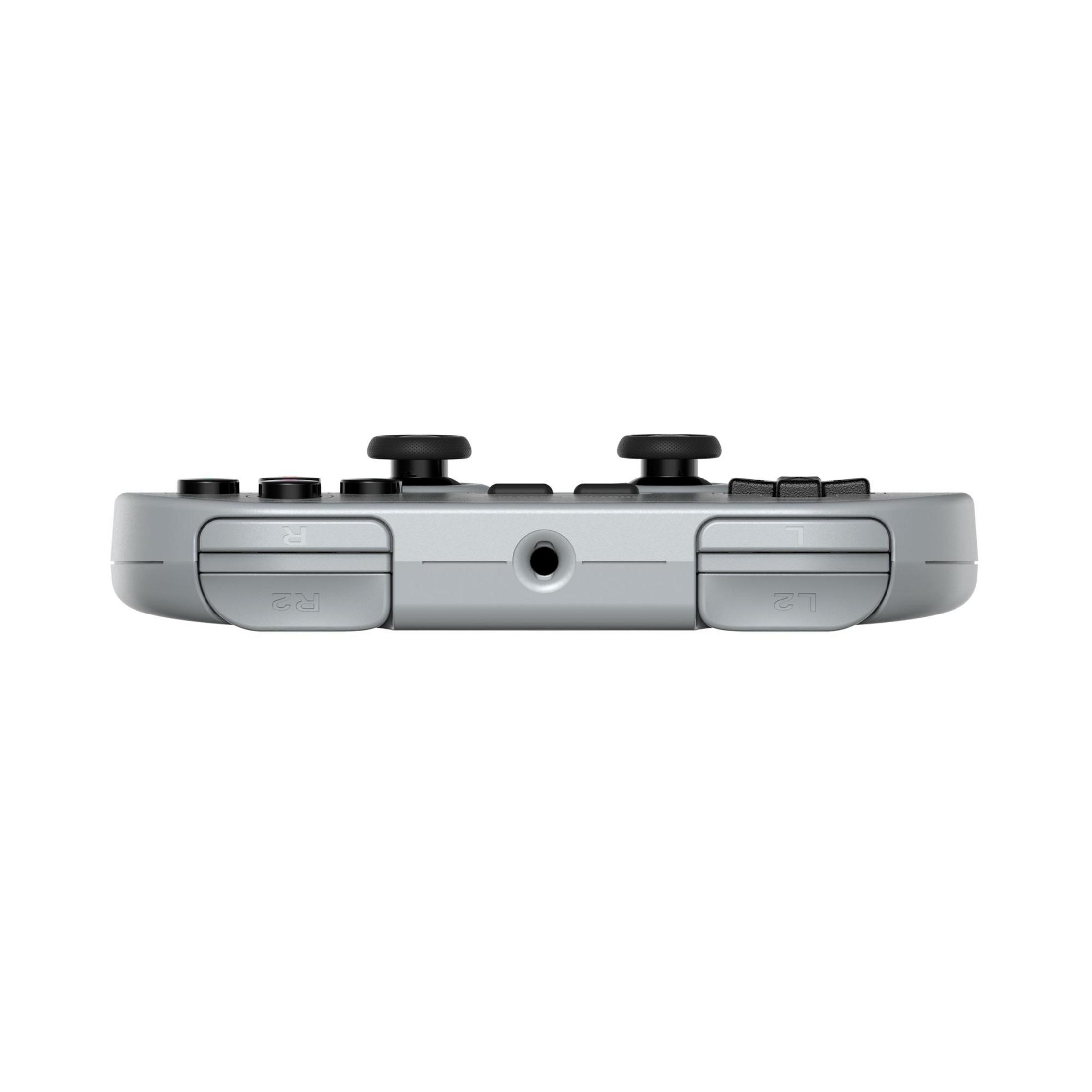 Un controller di gioco grigio con due joystick e pulsanti.
