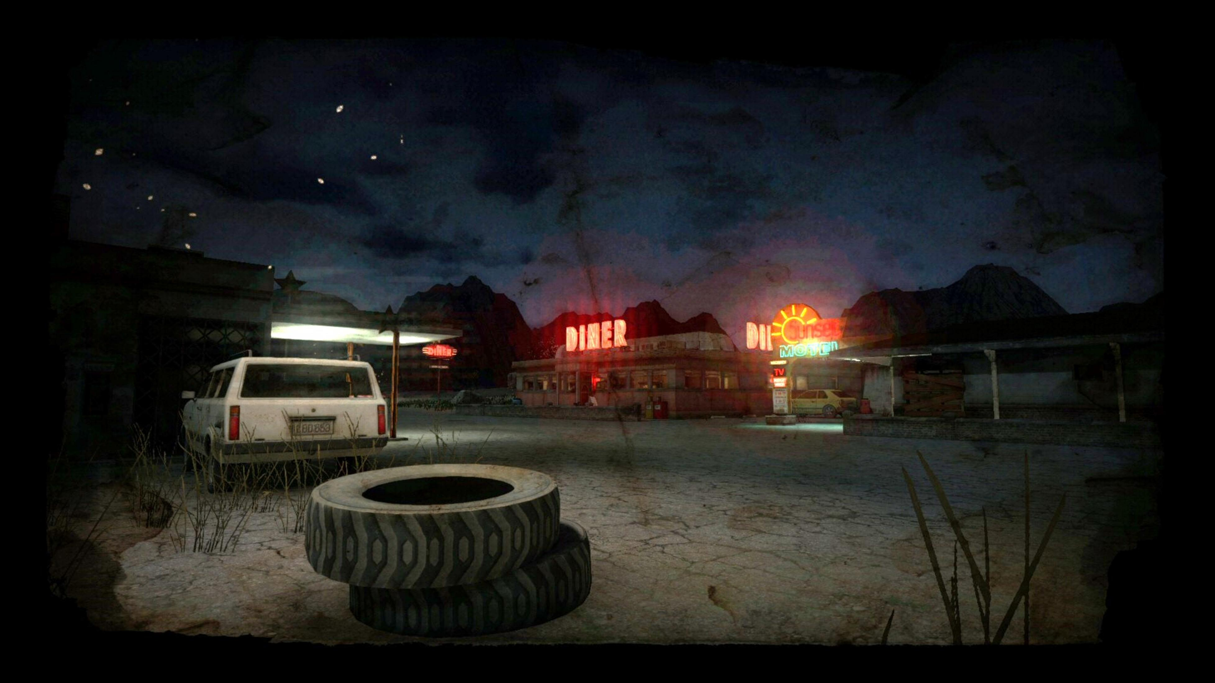 Ein Diner und Motel mit Neonschildern, ein weißer Wagen und Reifen bei Nacht.