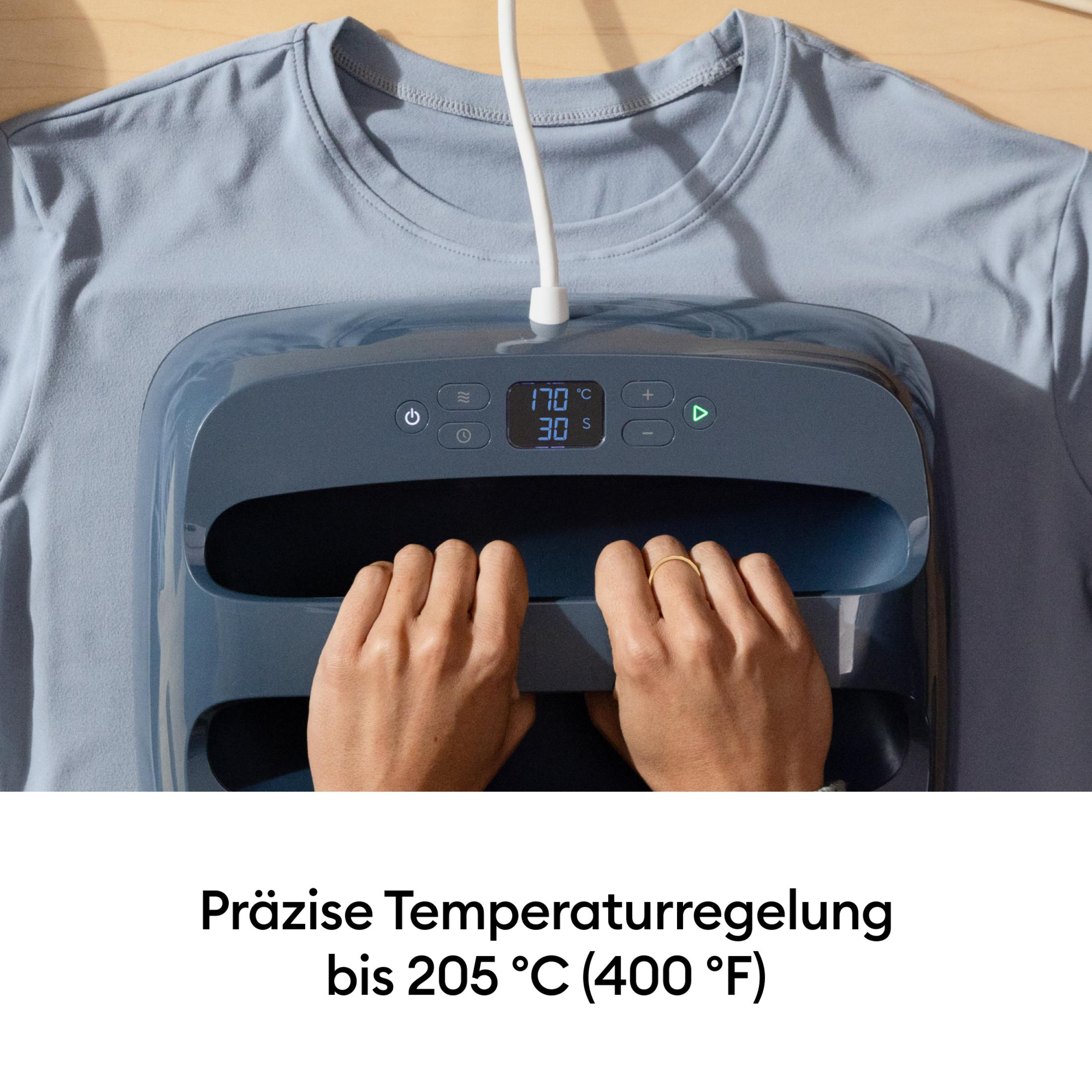 Manos operan una prensa de calor sobre una camiseta azul. La pantalla muestra 170°C, 30s.