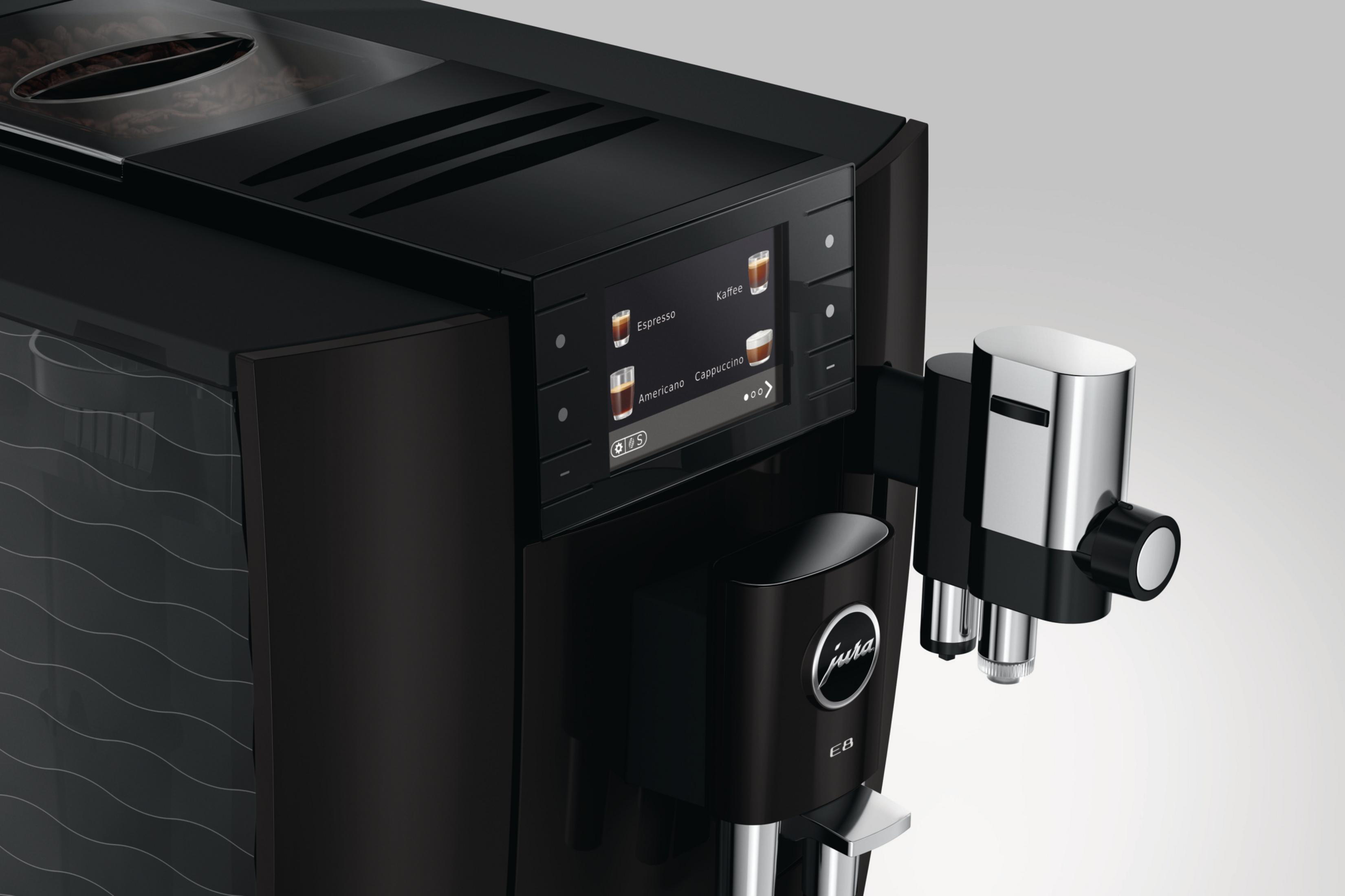 Macchina da caffè nera con touchscreen e accenti cromati. Chicchi di caffè visibili.