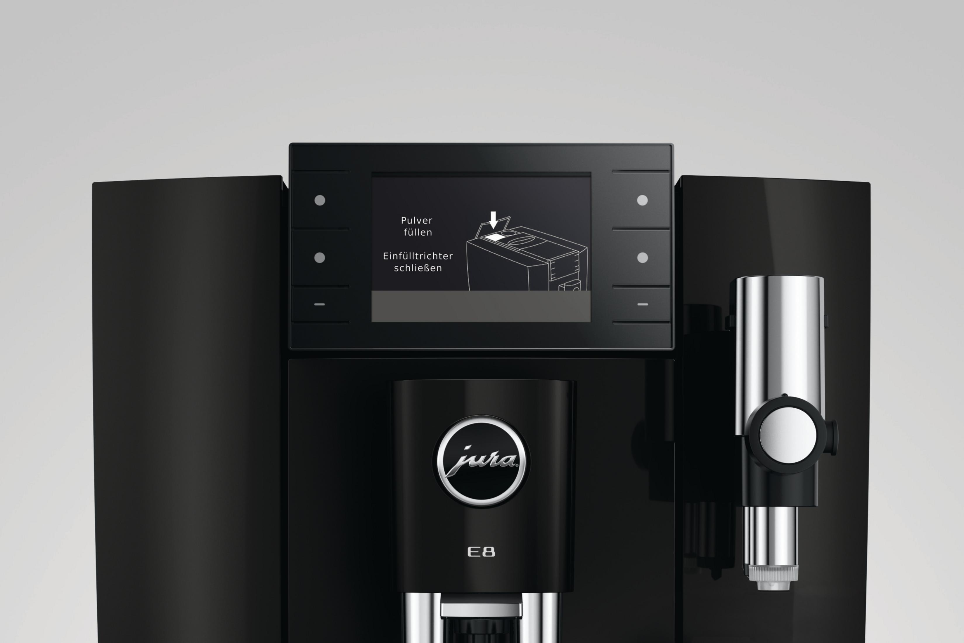 Una macchina da caffè nera con uno schermo che mostra istruzioni.