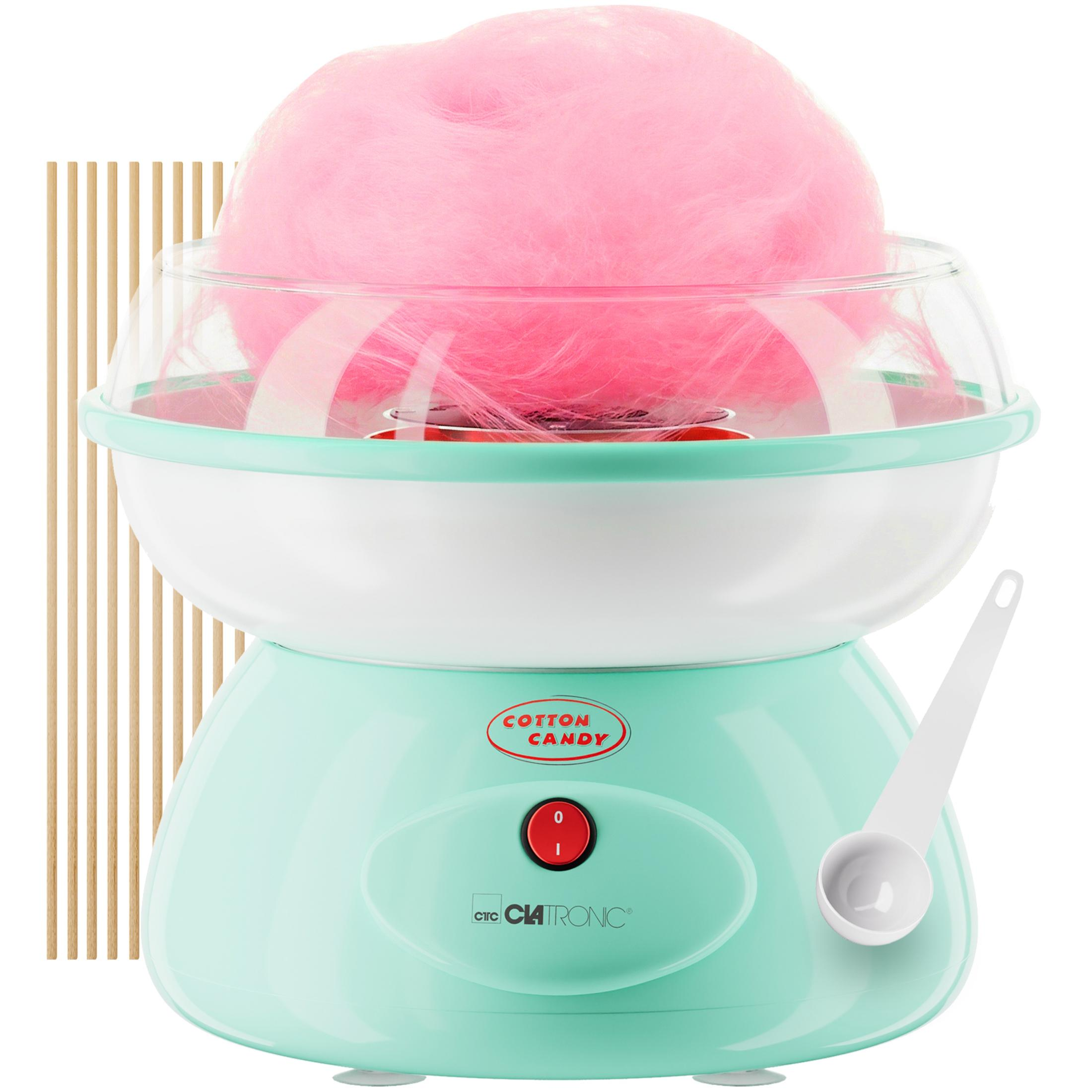 Ein mintgrüner Zuckerwattemaschine mit rosa Zuckerwatte und Löffel.