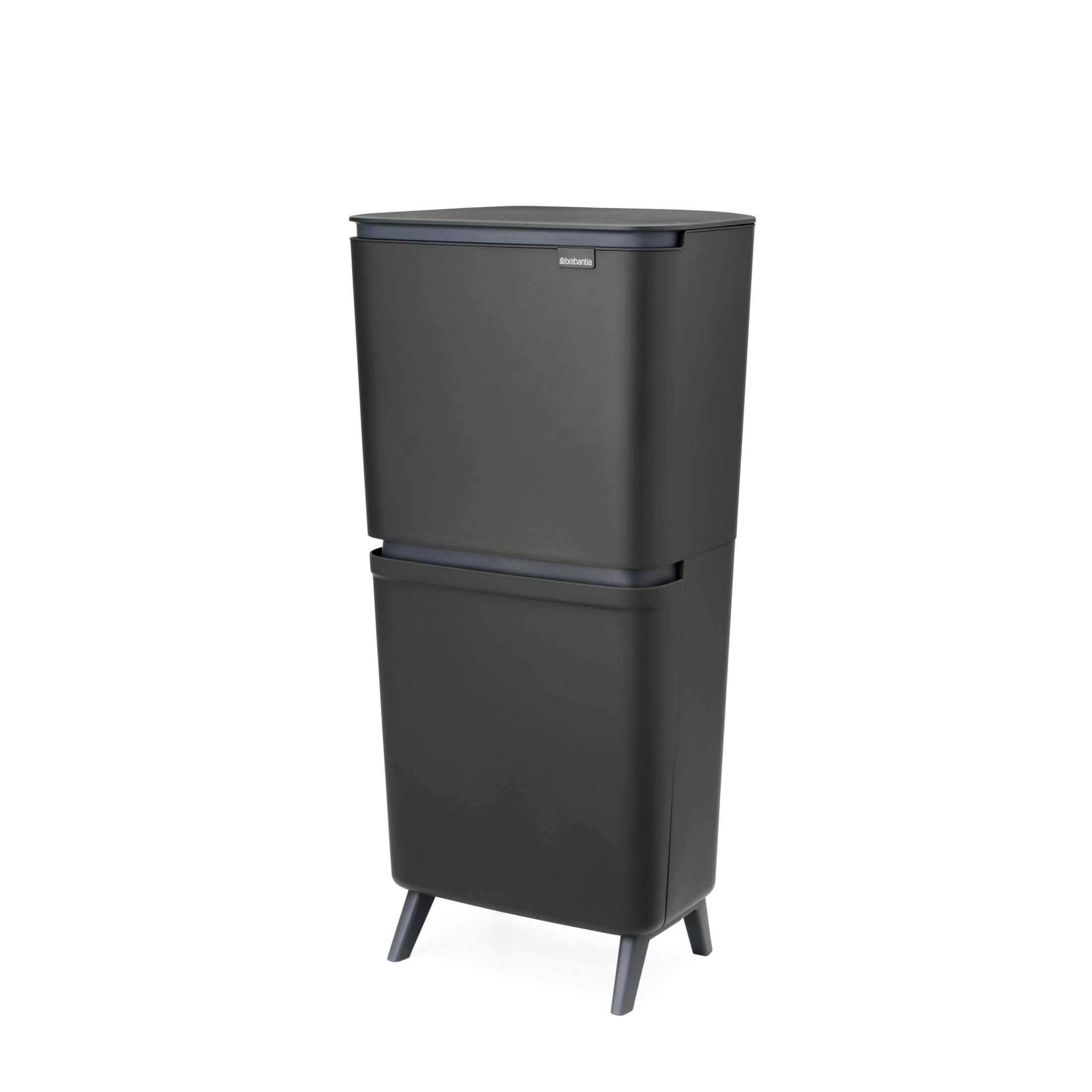 A tall, dark grey two-compartment recycling bin with four legs.