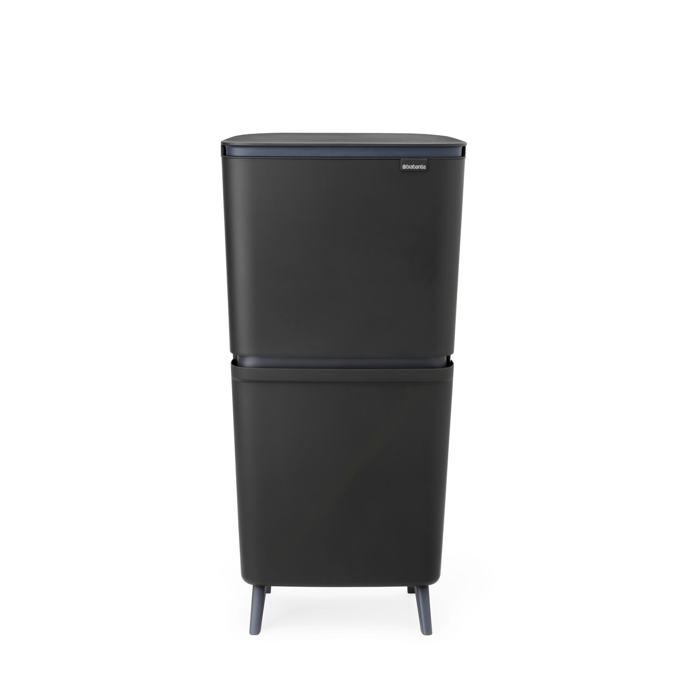 A dark, rectangular two-tier trash can stands on four legs.
