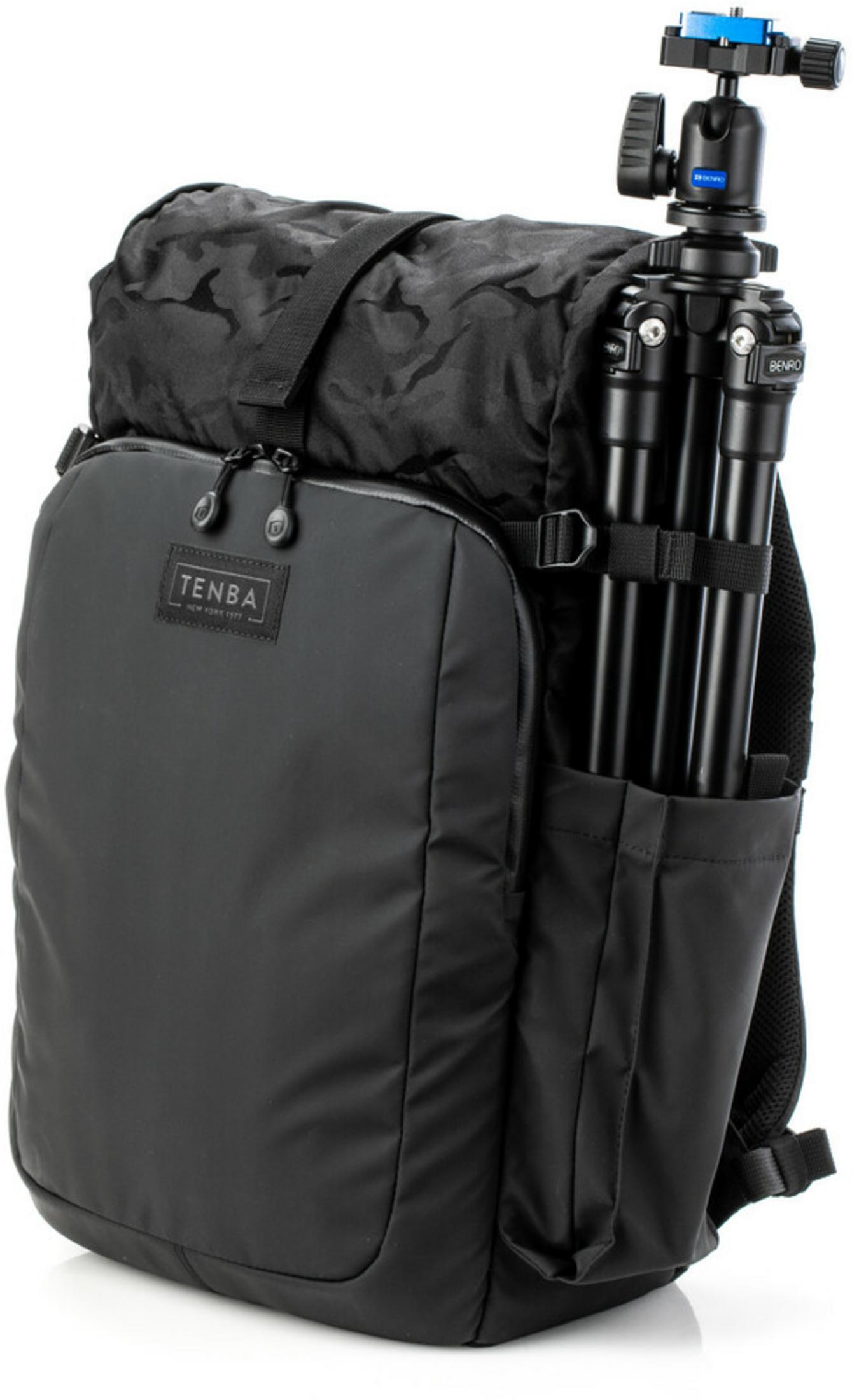 A black backpack with a black tripod secured to its side pocket.