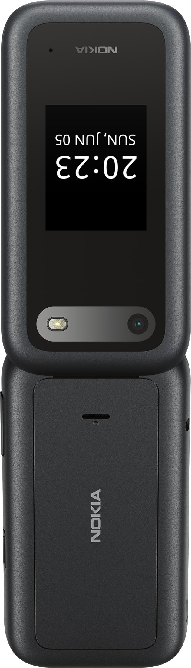 Un teléfono plegable Nokia negro con pantalla iluminada que muestra las 20:23.