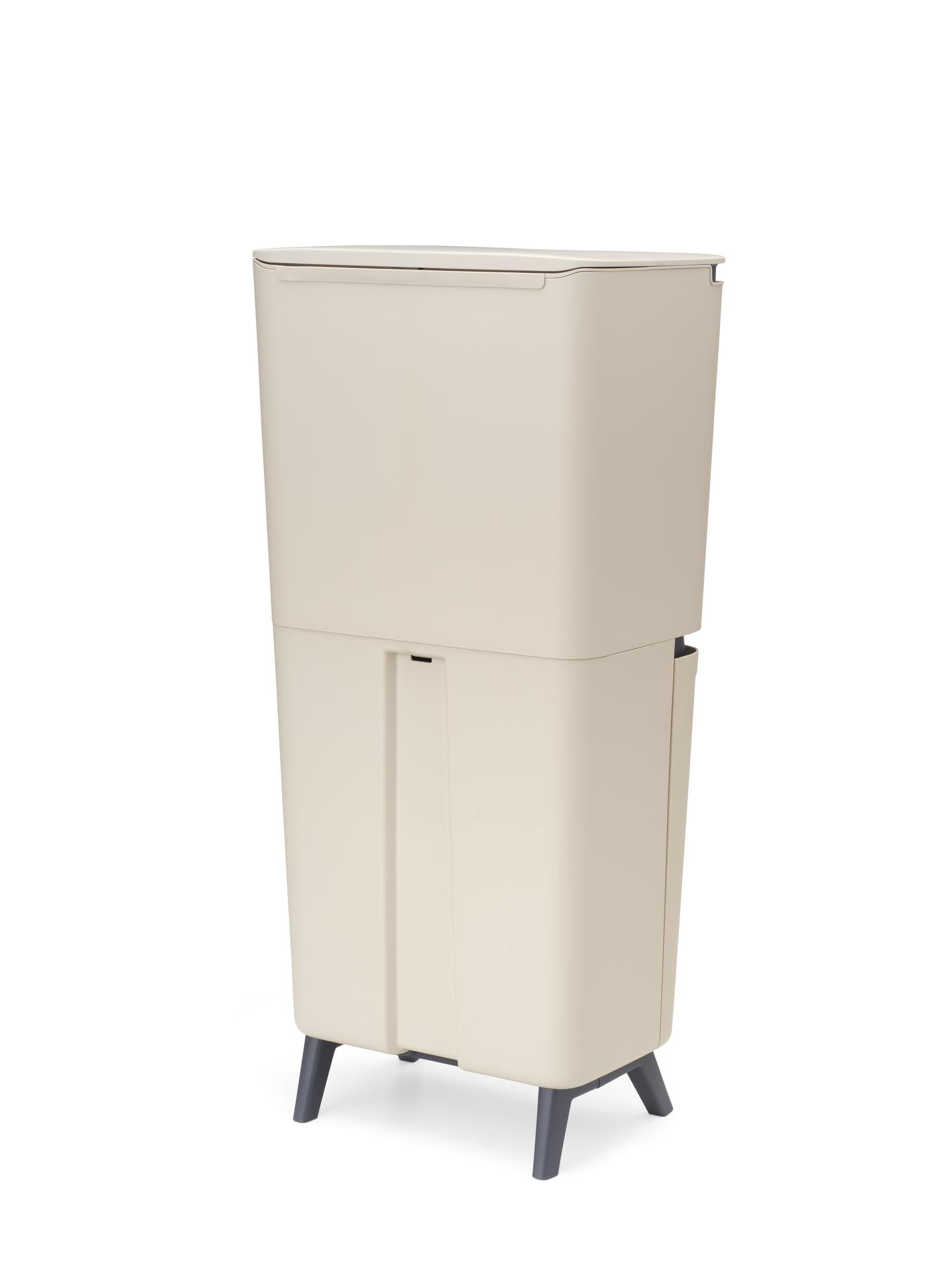 A beige two-compartment trash can stands on four dark gray legs.