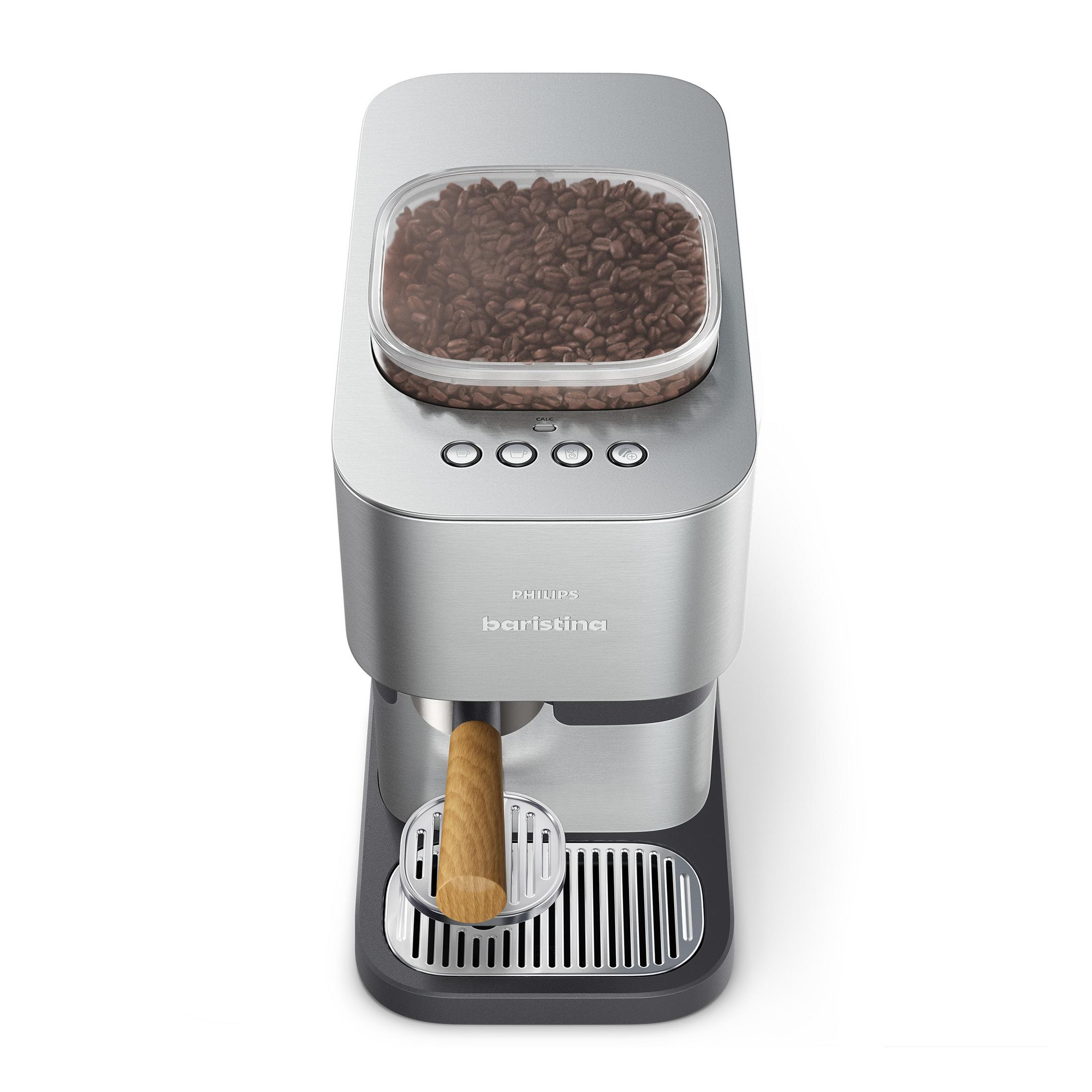Una macchina da caffè argentata con un contenitore pieno di chicchi di caffè in cima.