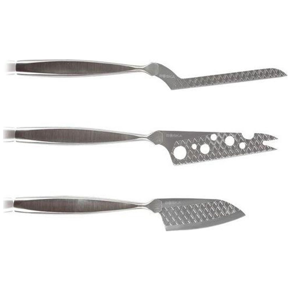 Three silver cheese knives with handles and serrated blades.