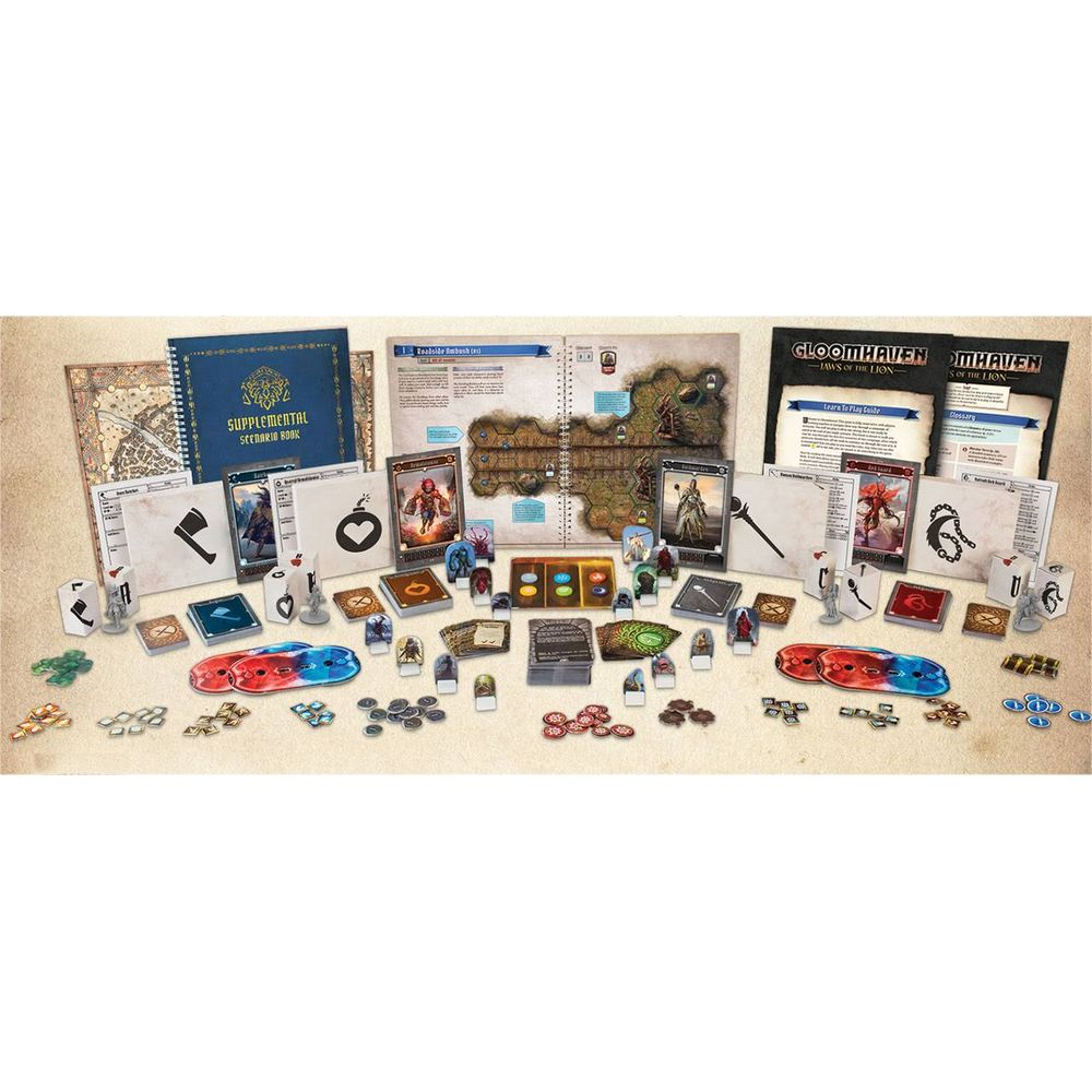 Componentes de juego de mesa sobre superficie beige: cartas, figuras, dados y libro abierto.