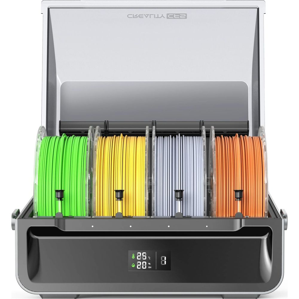 Un essiccatore per filamenti per stampante 3D con quattro bobine: verde, giallo, grigio e arancione.