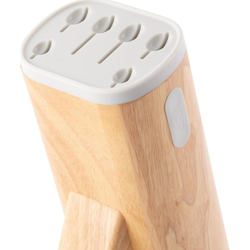 Wooden block with white lid and slots for cutlery, on a white background.