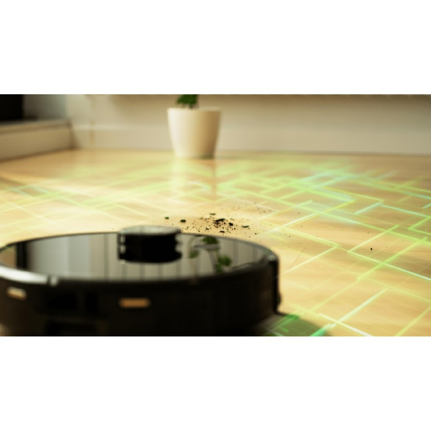 Un robot aspirapolvere nero pulisce un pavimento in legno con particelle di sporco.