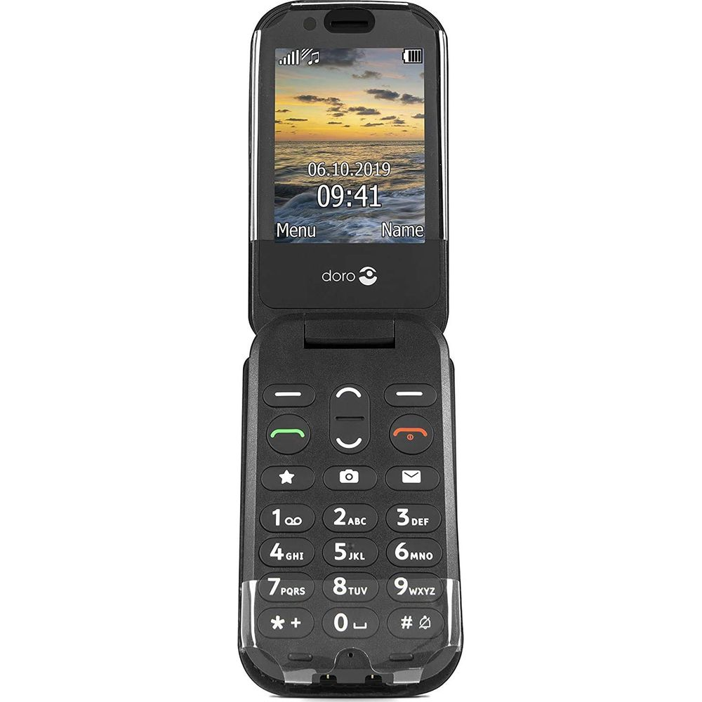 Un telefono a conchiglia Doro nero che mostra un tramonto sul suo schermo e tastiera.