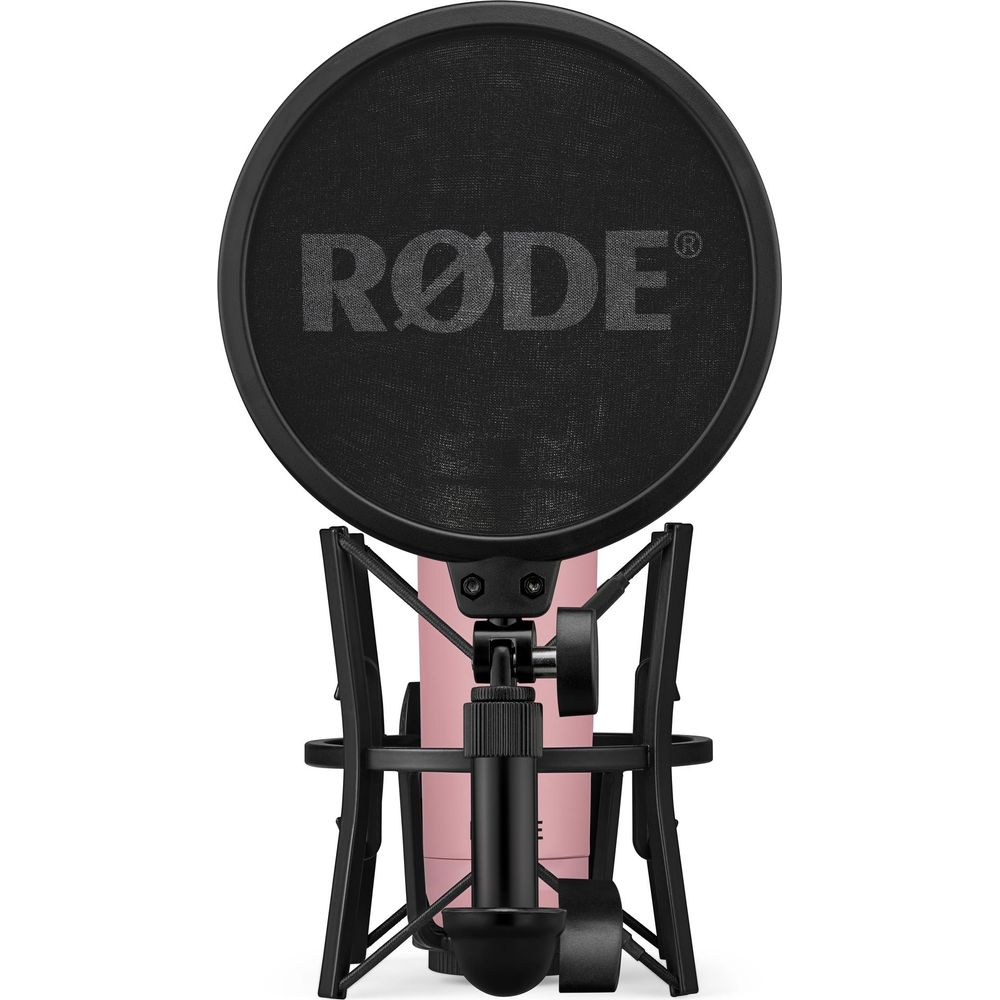Un microfono rosa con filtro anti-pop e supporto neri.