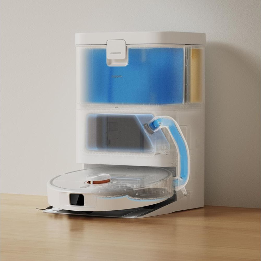 Ein weißer Saugroboter mit Ladestation, die blaue und gelbe Flüssigkeit enthält.