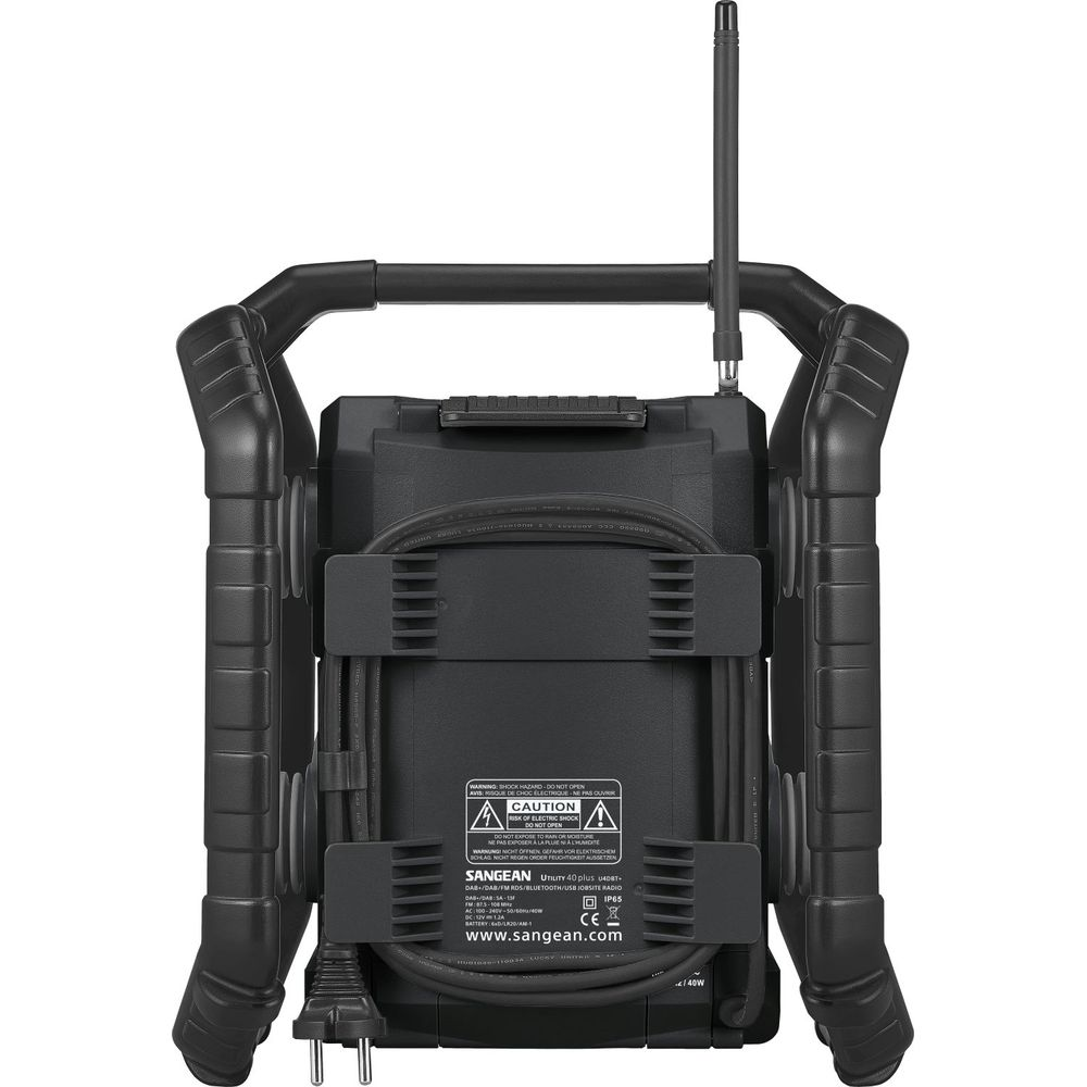 Vista posteriore di una radio nera con manici, cavo e antenna. Etichetta con avvertenze.