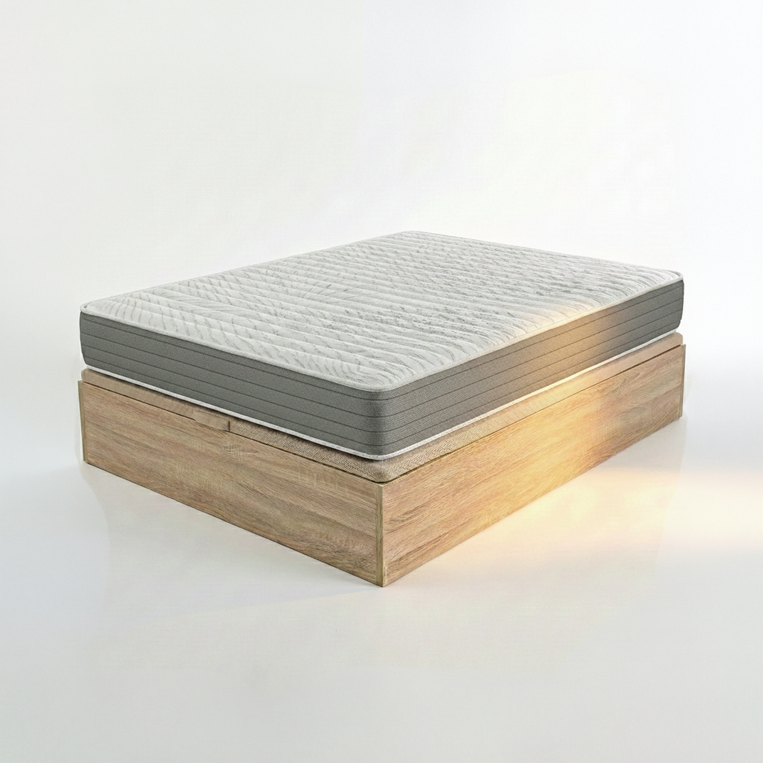 Un colchón blanco con borde gris descansa sobre una base de cama de madera. Iluminación de estudio.