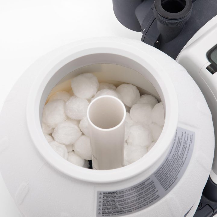 Witte filterballen vullen een witte container met een centrale buis.