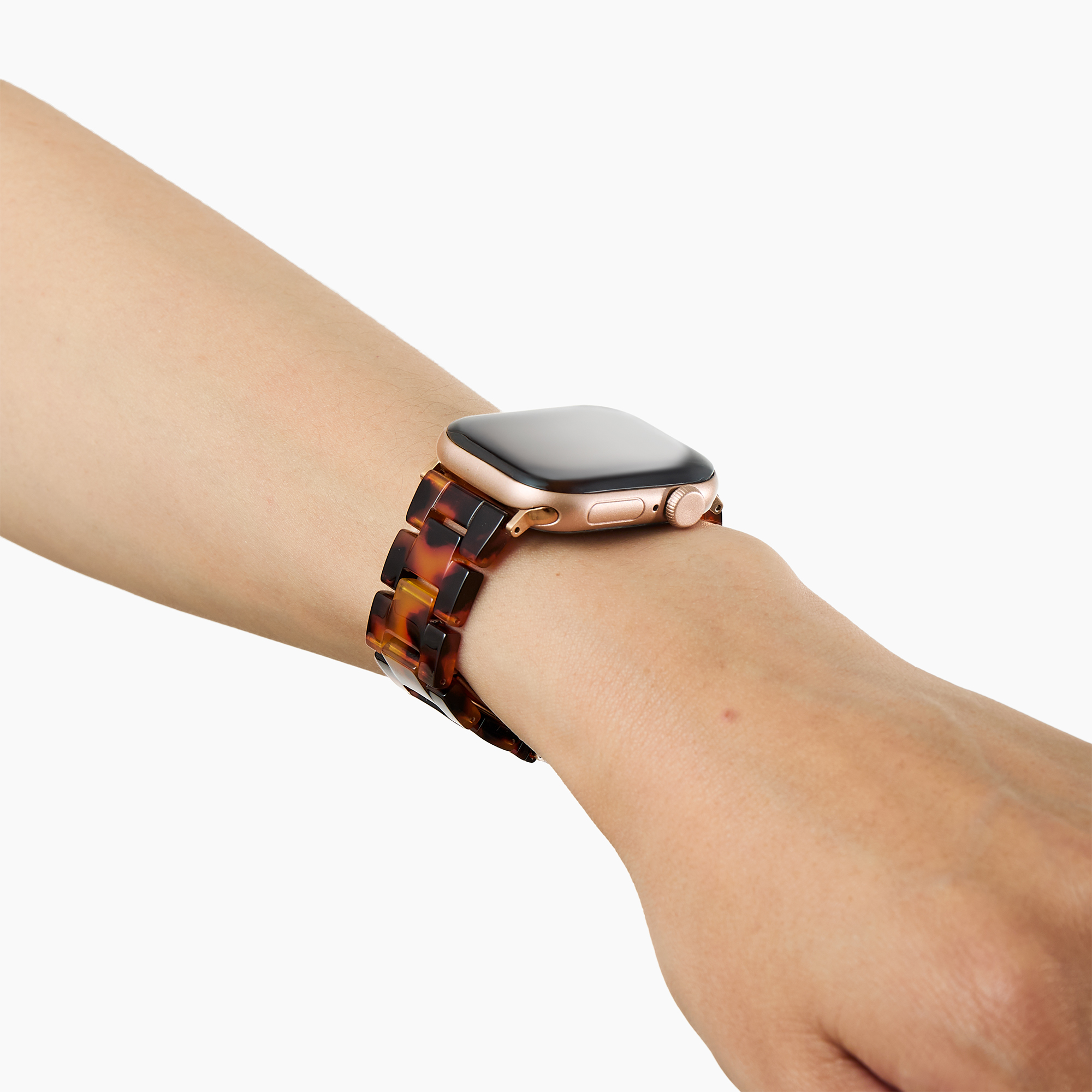 Eine goldene Smartwatch mit Schildpattband an einem Arm.