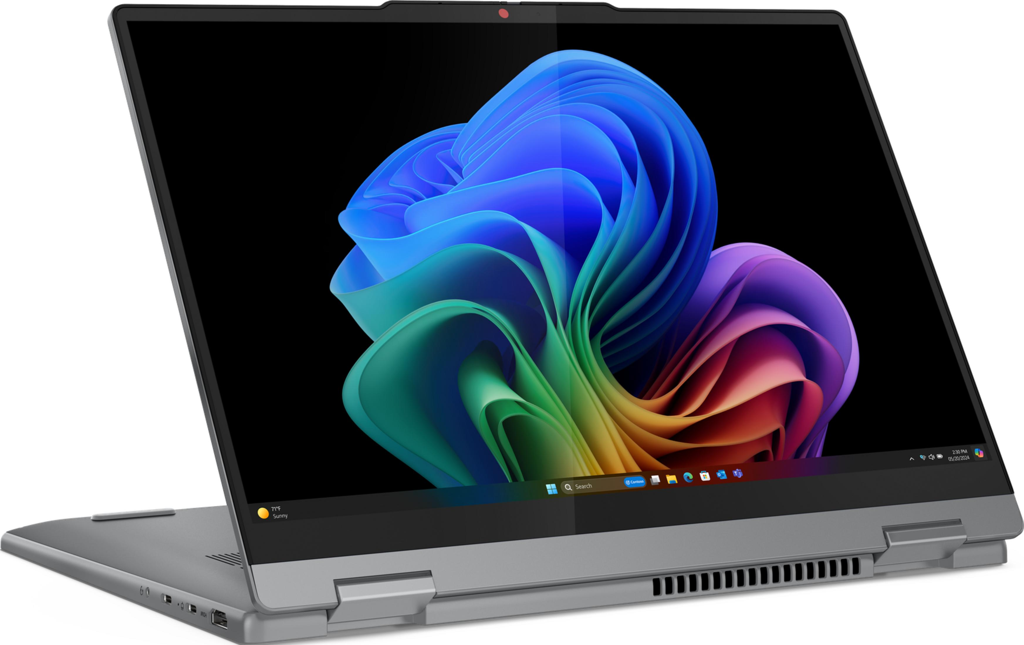 Ein silberner Laptop mit offenem Bildschirm, der ein buntes abstraktes Hintergrundbild zeigt.