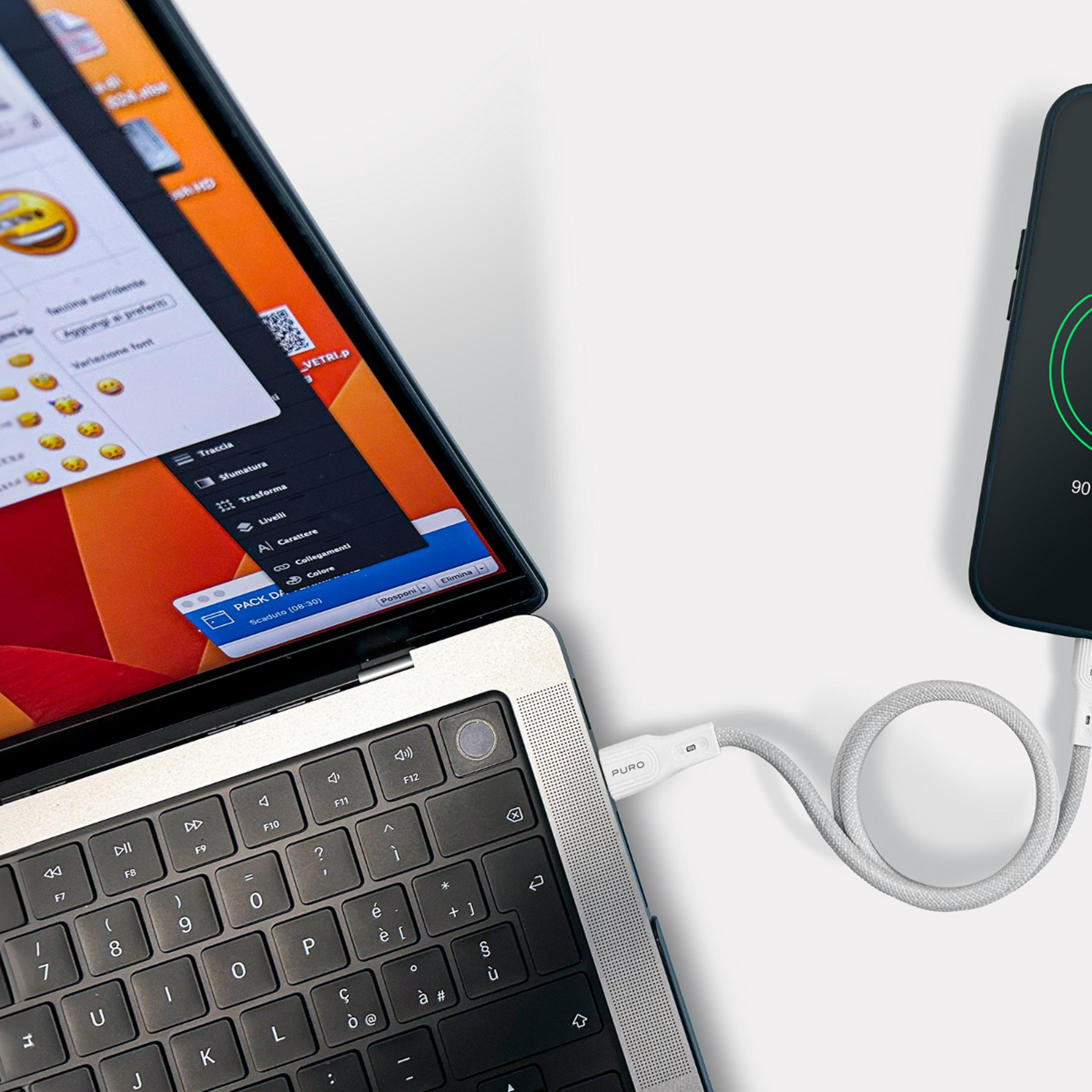 Ein Laptop ist mit einem Smartphone verbunden, das über ein Kabel aufgeladen wird.