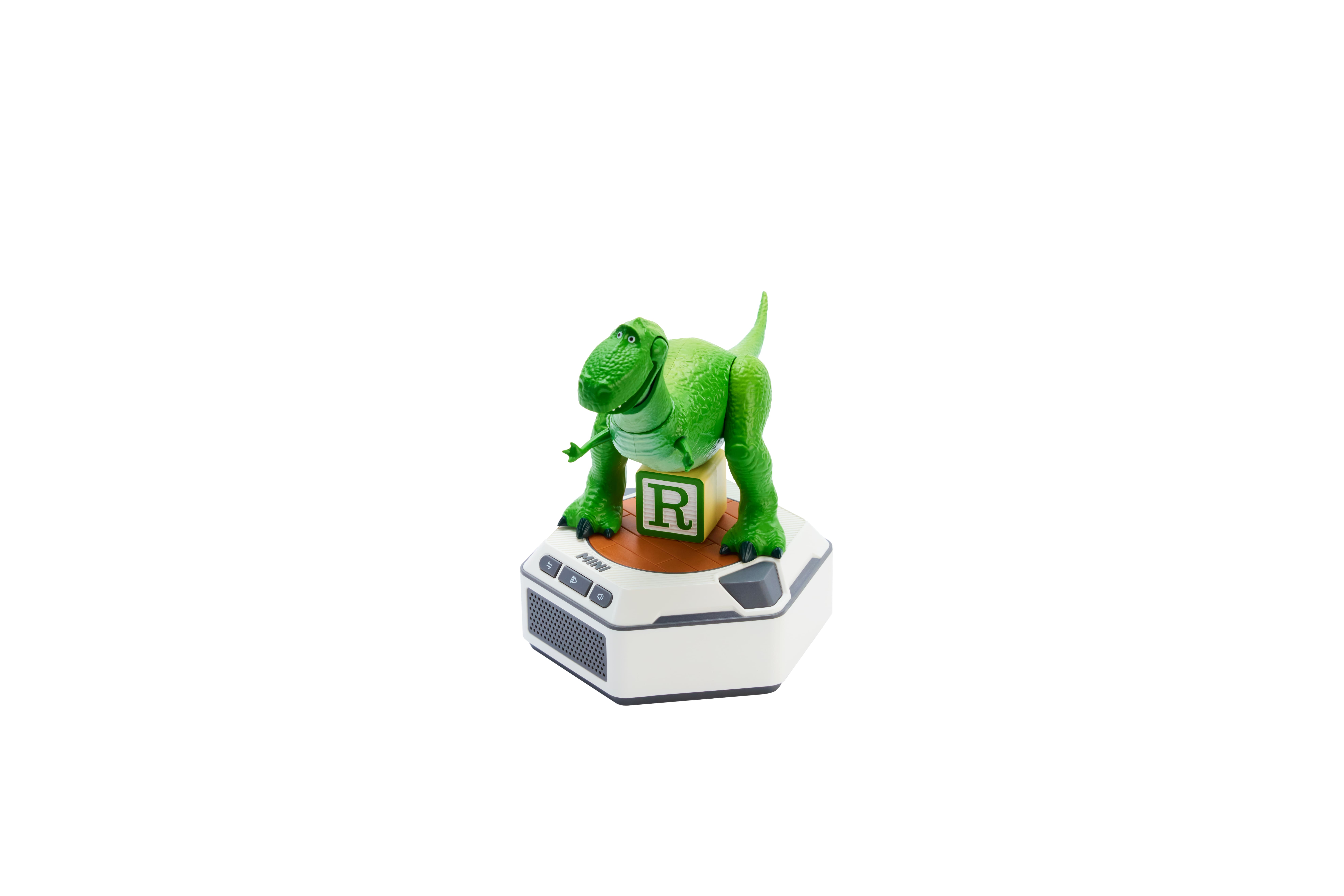 Juguete de dinosaurio verde sobre pedestal blanco con bloque "R".