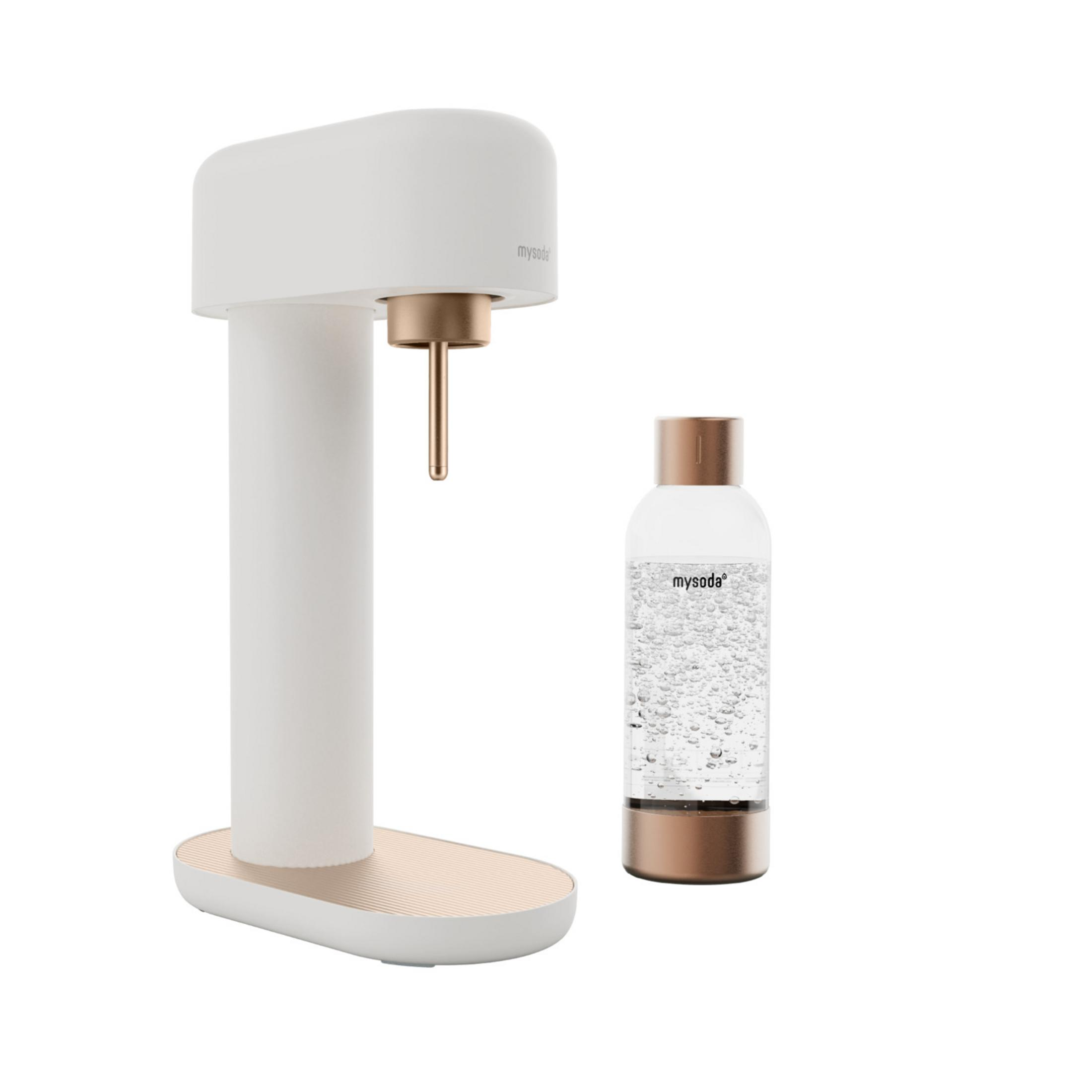 A white soda maker with copper accents stands next to a filled glass bottle.