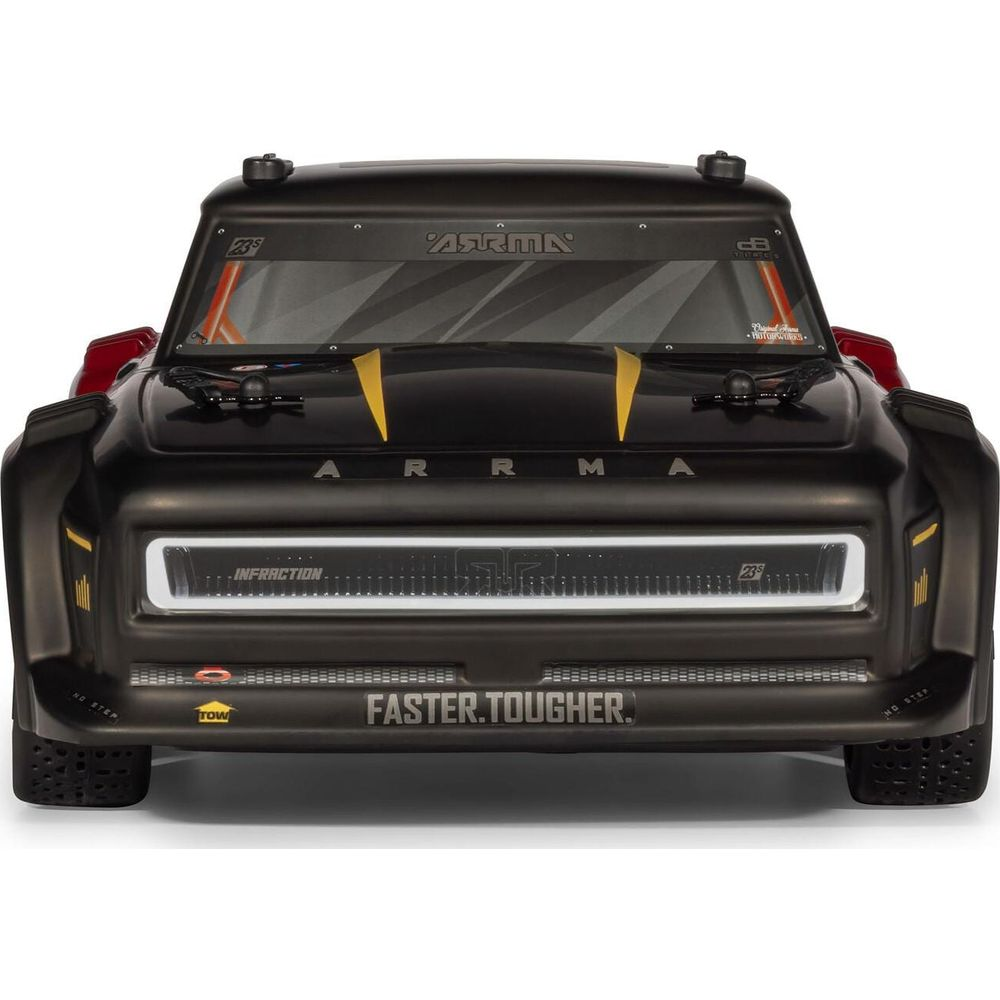 Camioneta negra a control remoto con parrilla blanca y detalles amarillos. Texto 'FASTER.TOUGHER.'