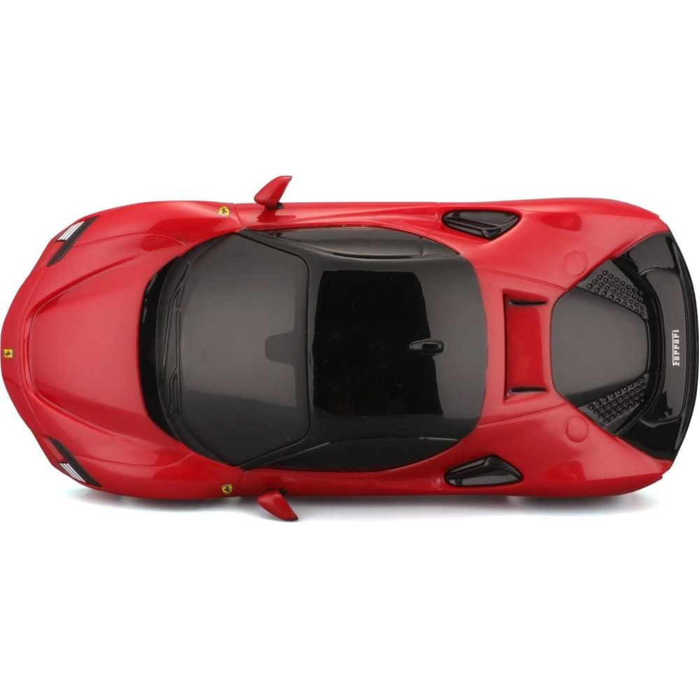 Roter Ferrari von oben, mit schwarzem Dach und Fenstern.