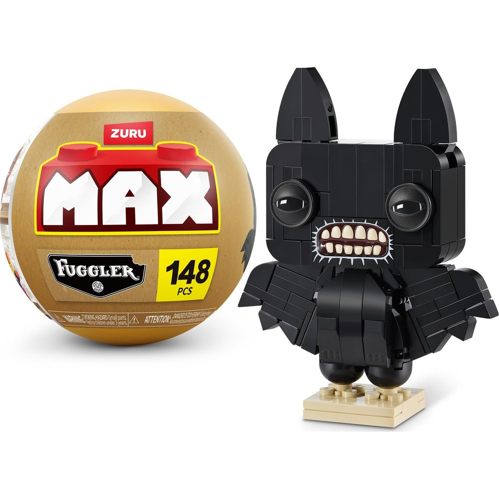 Schwarzer Fuggler-Bausatz neben einer runden gelben Verpackung mit "MAX FUGGLER".