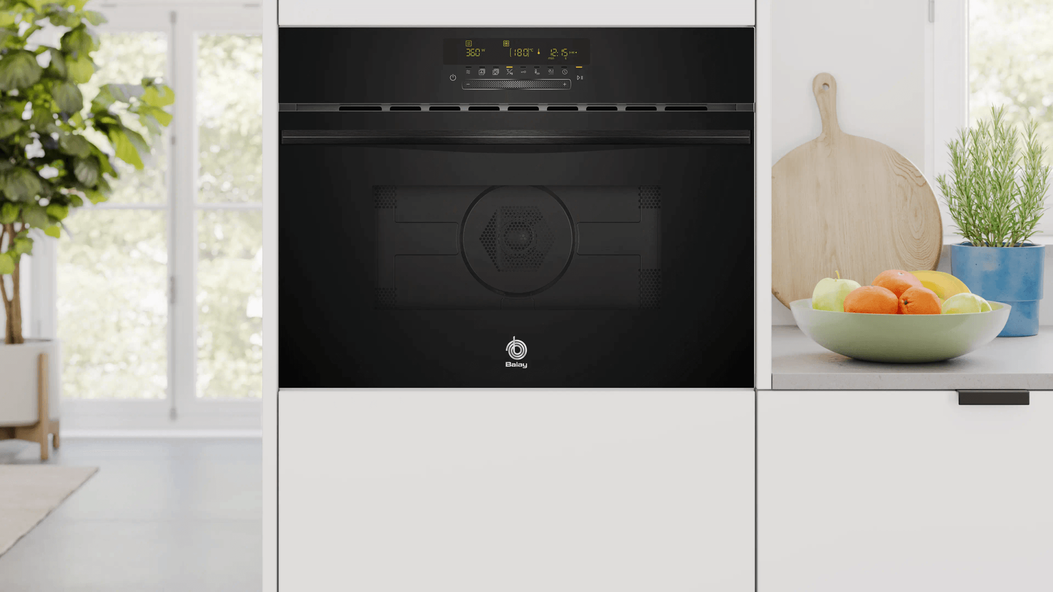 Horno empotrable negro moderno con pantalla digital y frutero al lado.