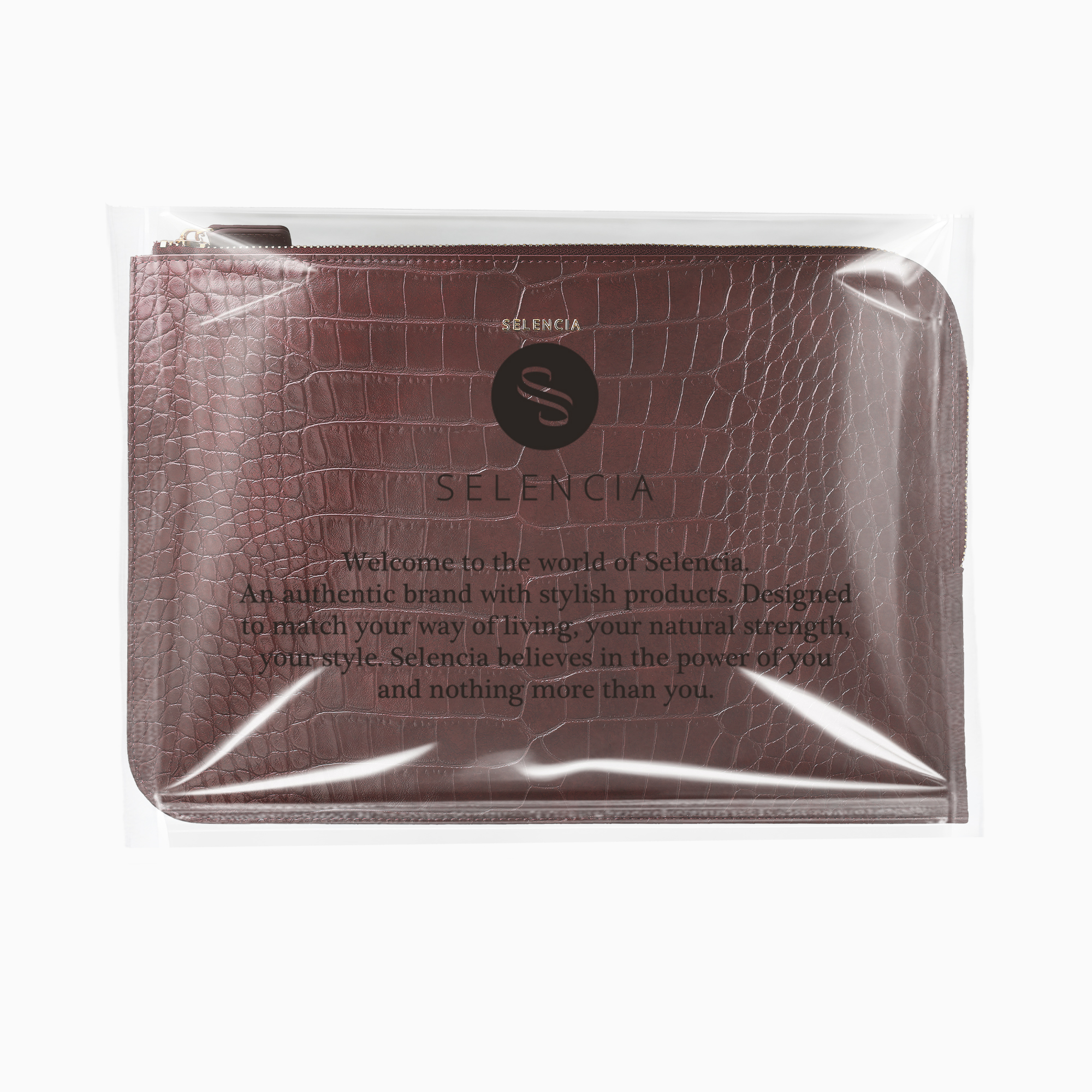 Braune Kroko-Muster-Tasche in Plastikfolie mit Logo und Text.