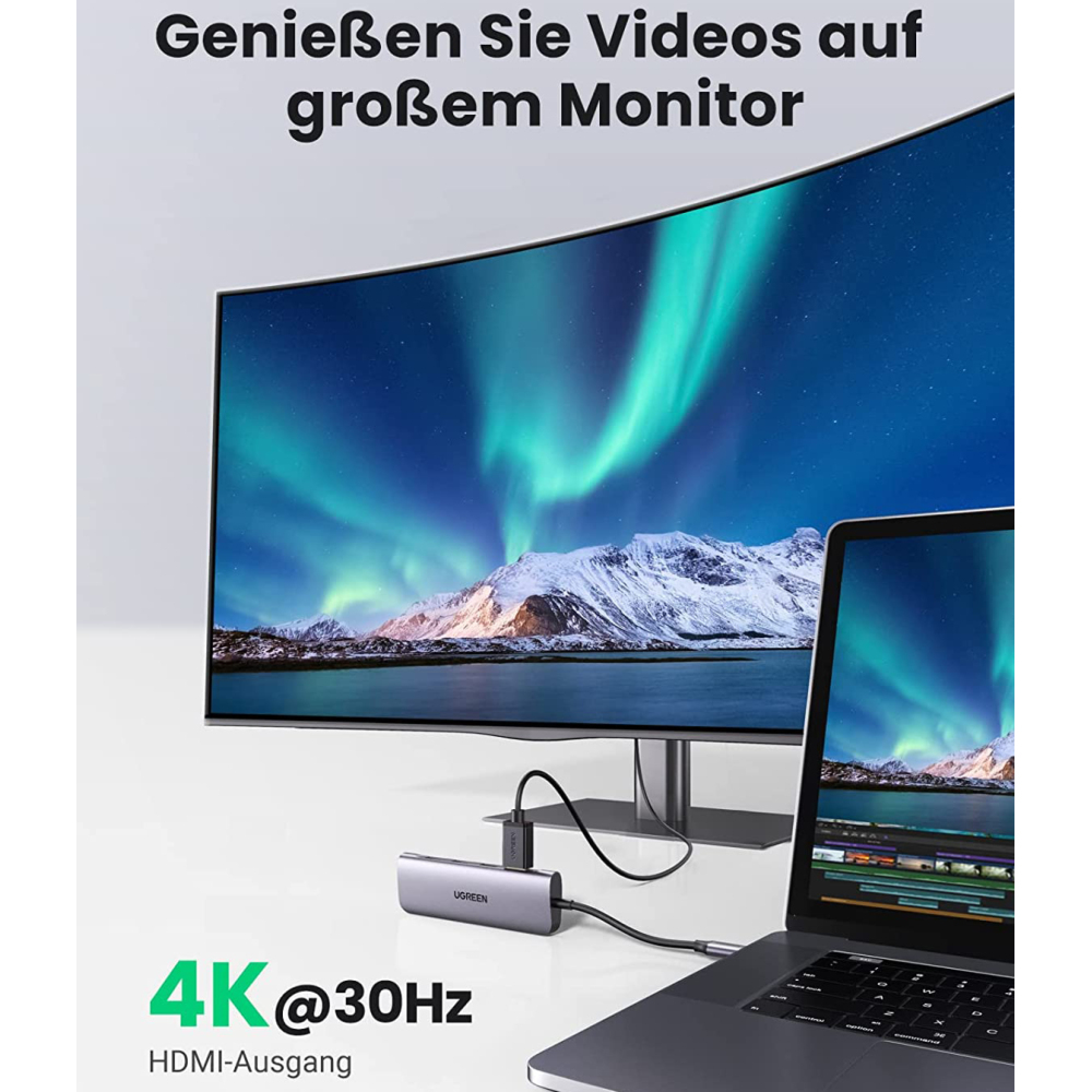 Ein Laptop und ein großer Monitor mit Nordlichtern. Ein USB-C-Hub verbindet sie.