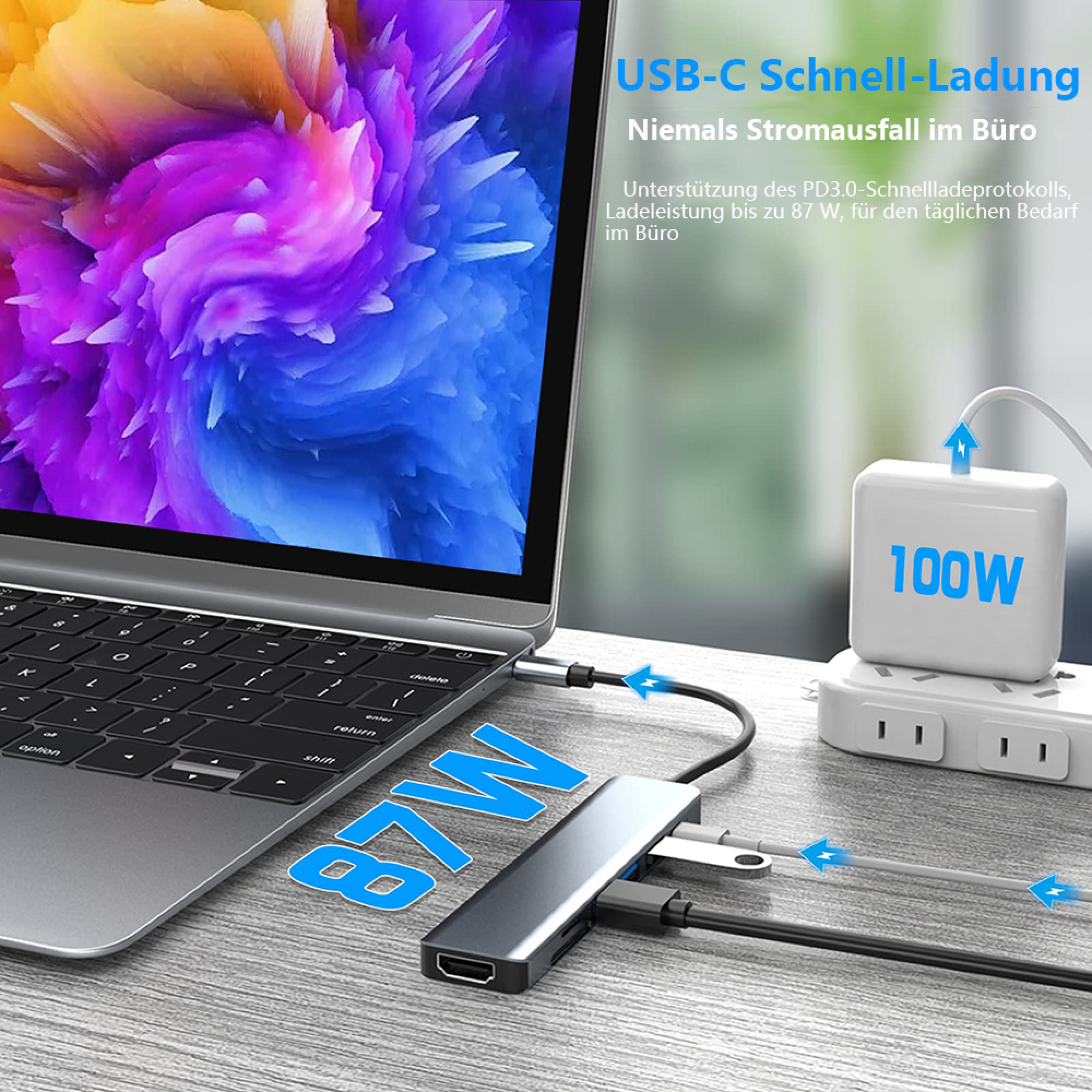 Ein Laptop ist mit einem USB-C-Hub verbunden, der 87W leistet. Ein 100W Netzteil ist im Hintergrund zu sehen.