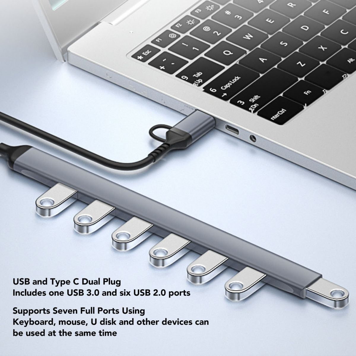 Ein grauer USB-Hub mit sieben Anschlüssen ist an einen Laptop angeschlossen.
