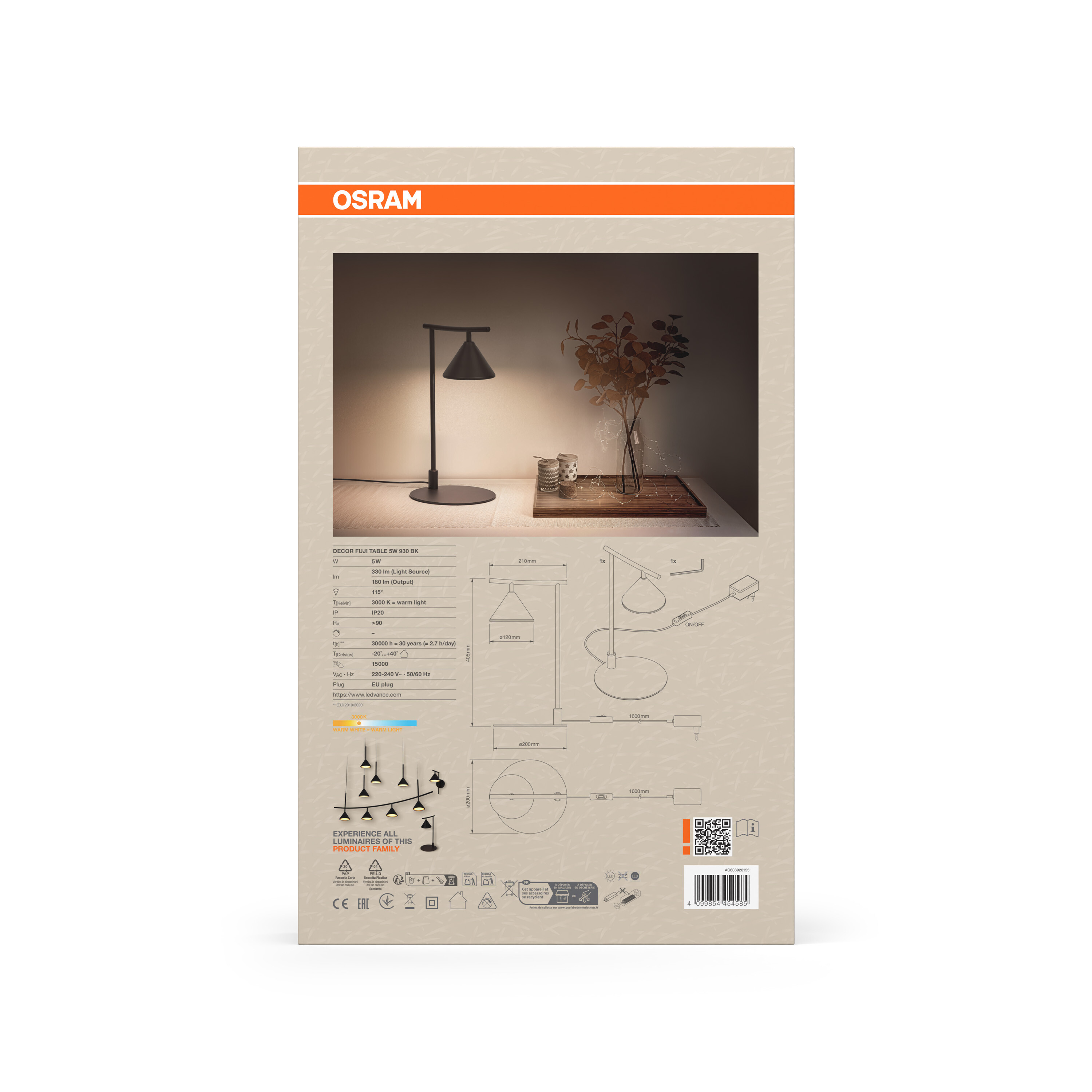 Moderne schwarze Schreibtischlampe mit konischem Lampenschirm und einem Glas mit Zweigen.
