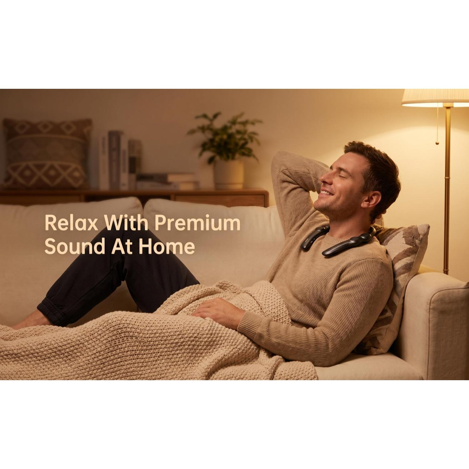 Mann entspannt auf Sofa mit Nackenlautsprechern und Decke. Text: Entspanne mit Premium-Sound zu Hause.