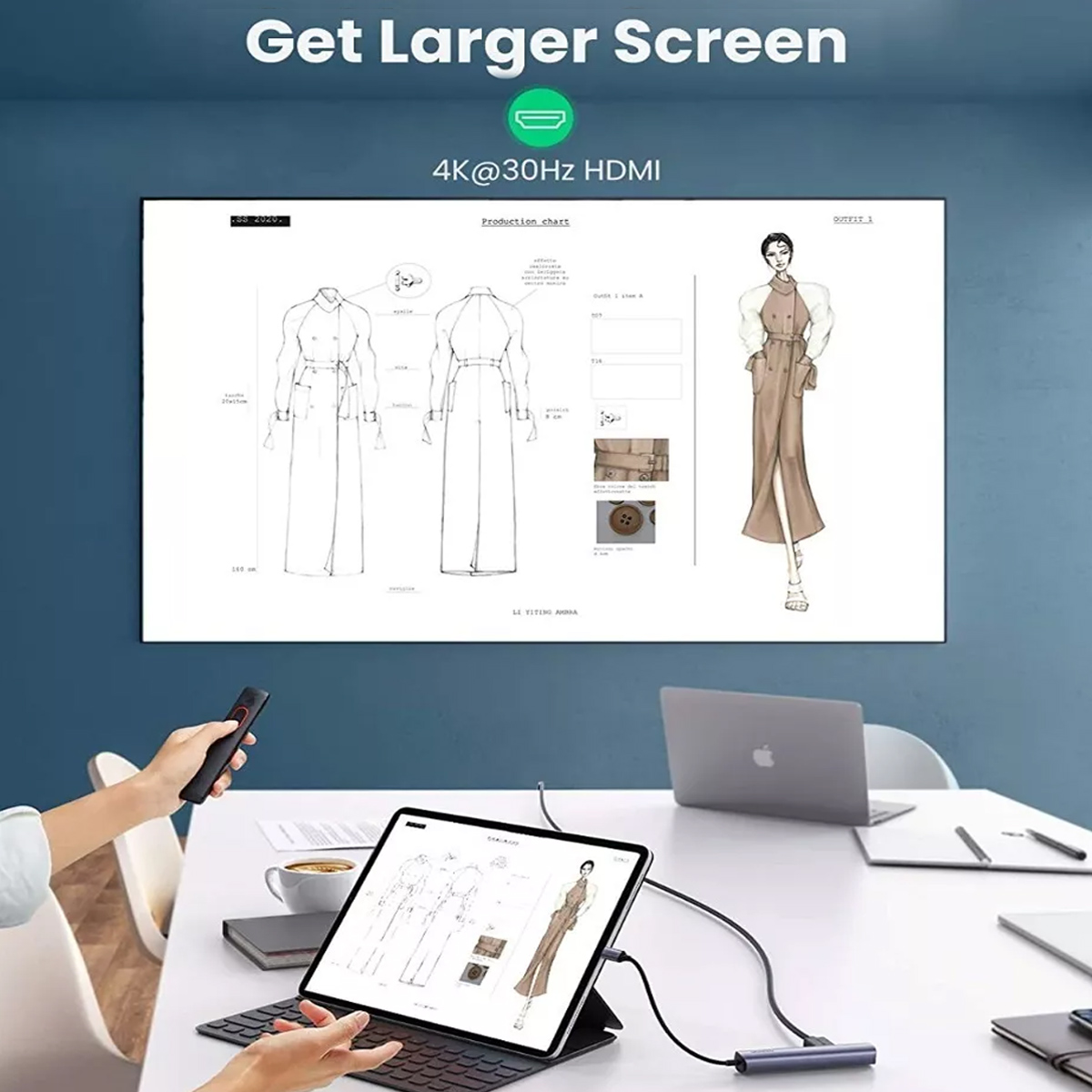 Eine Person bedient ein Tablet, das mit einem großen Bildschirm verbunden ist, der Modedesigns zeigt.