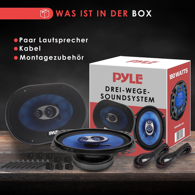 Lautsprecher-Set mit Box, Kabeln und Montagezubehör auf Holztisch.
