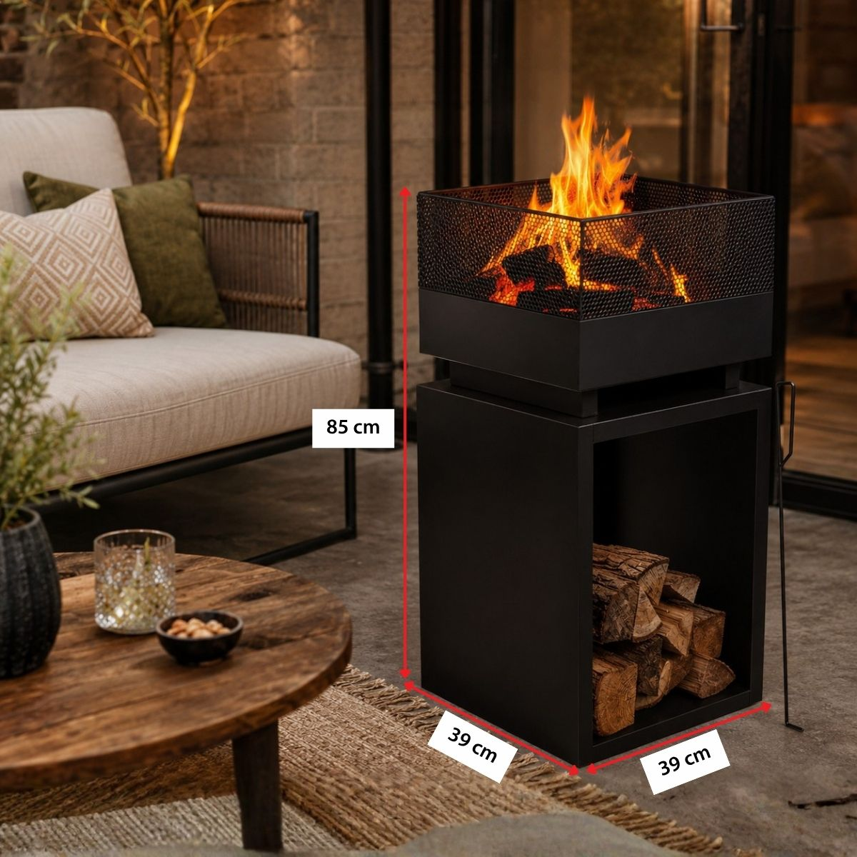 A black fire pit with a mesh top and flames burns above a storage compartment with logs.