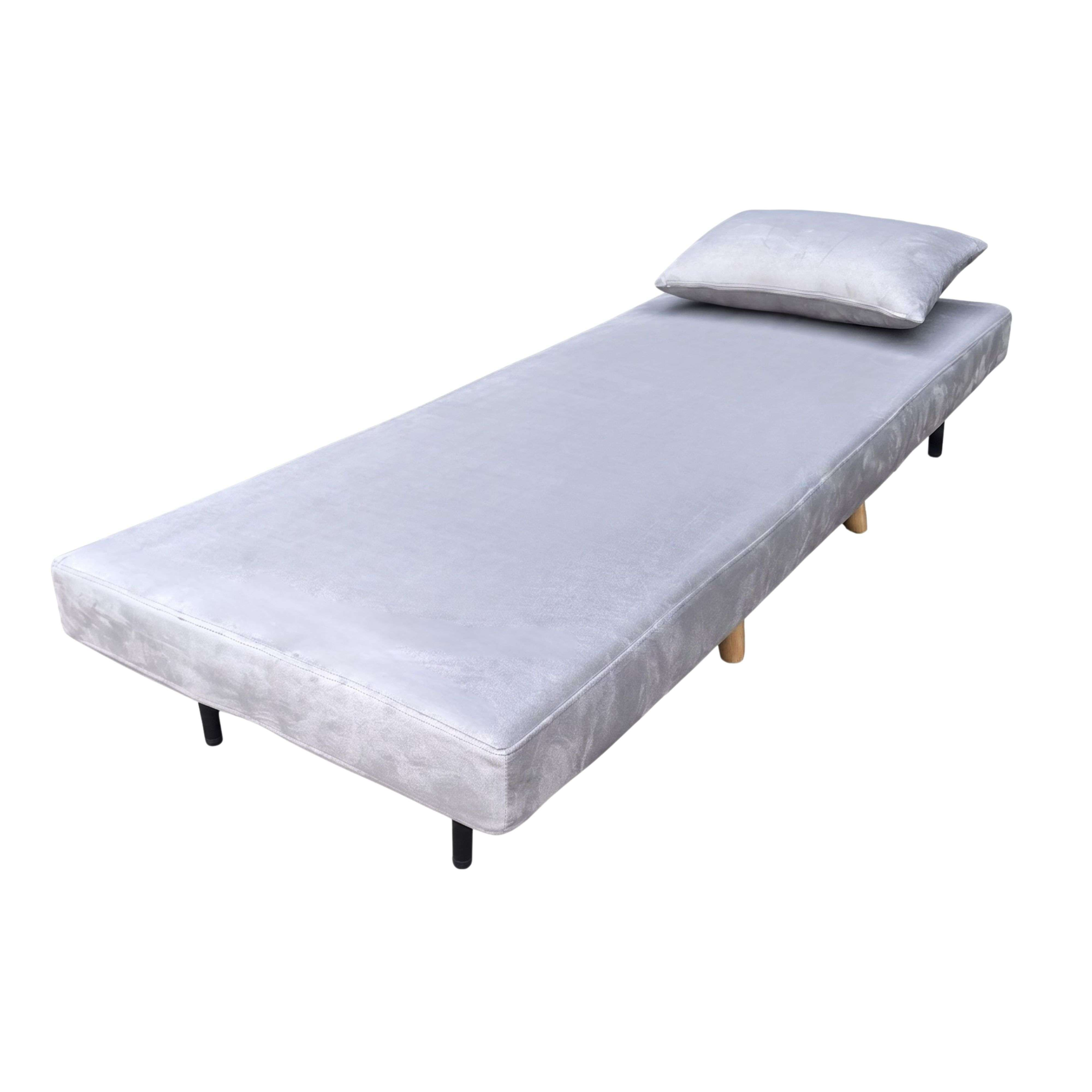 Una cama estrecha gris con una almohada y patas negras.